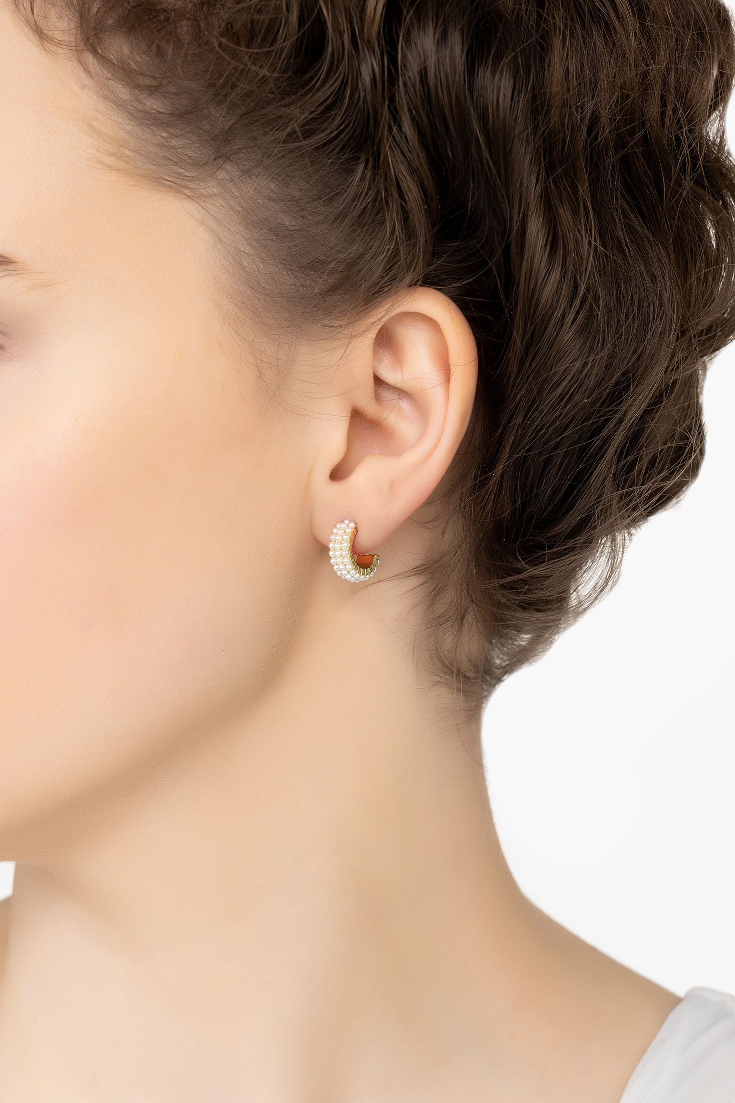 Angled view of Pearly Queen Hoop Earrings Gold, showing pearl detailing, gold finish and the jewellery profile.