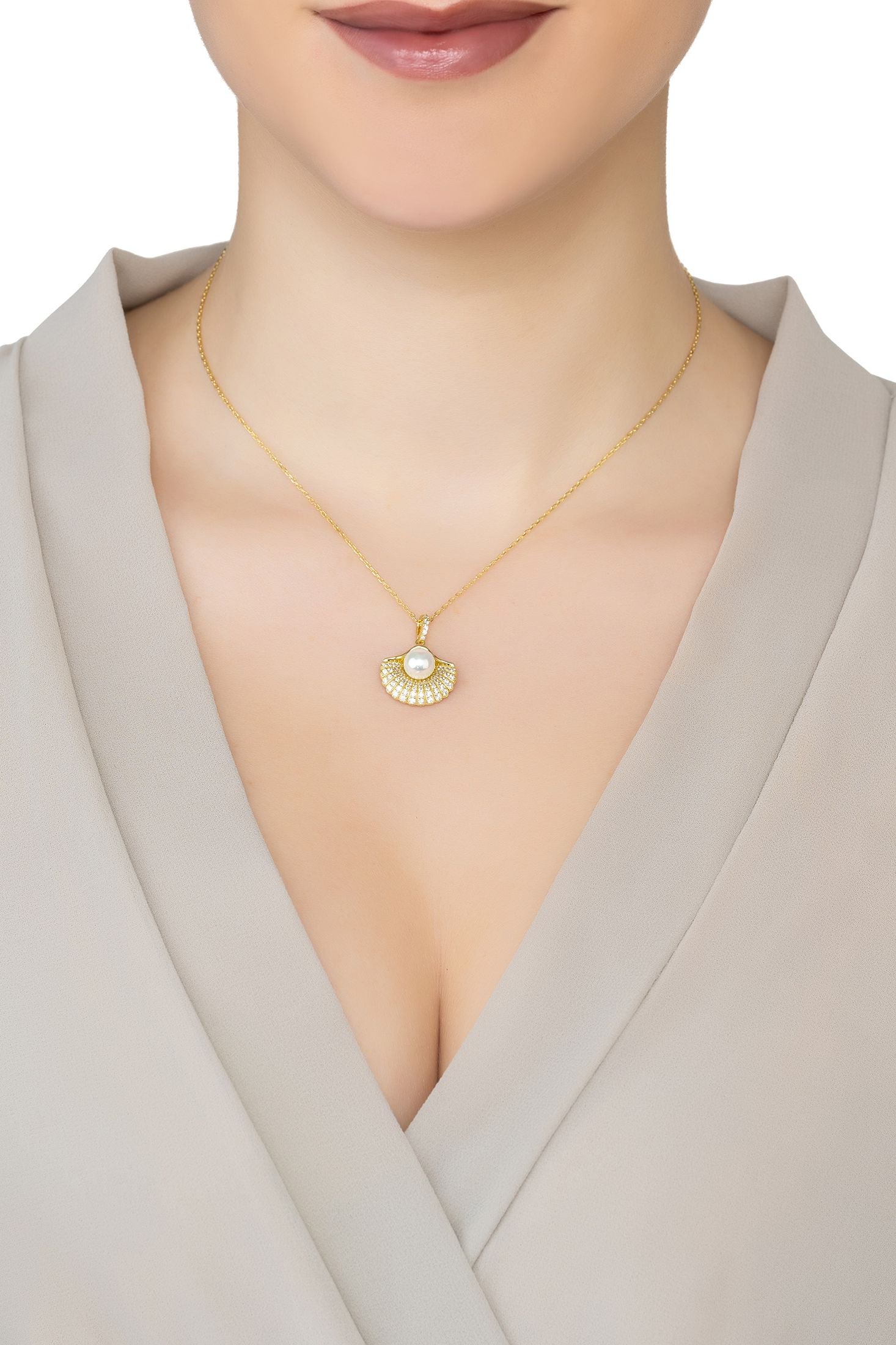 Angled view of Deco Fan And Pearl Shell Pendant Necklace Gold, showing shell design, pearl detailing, gold finish and the jewellery profile.