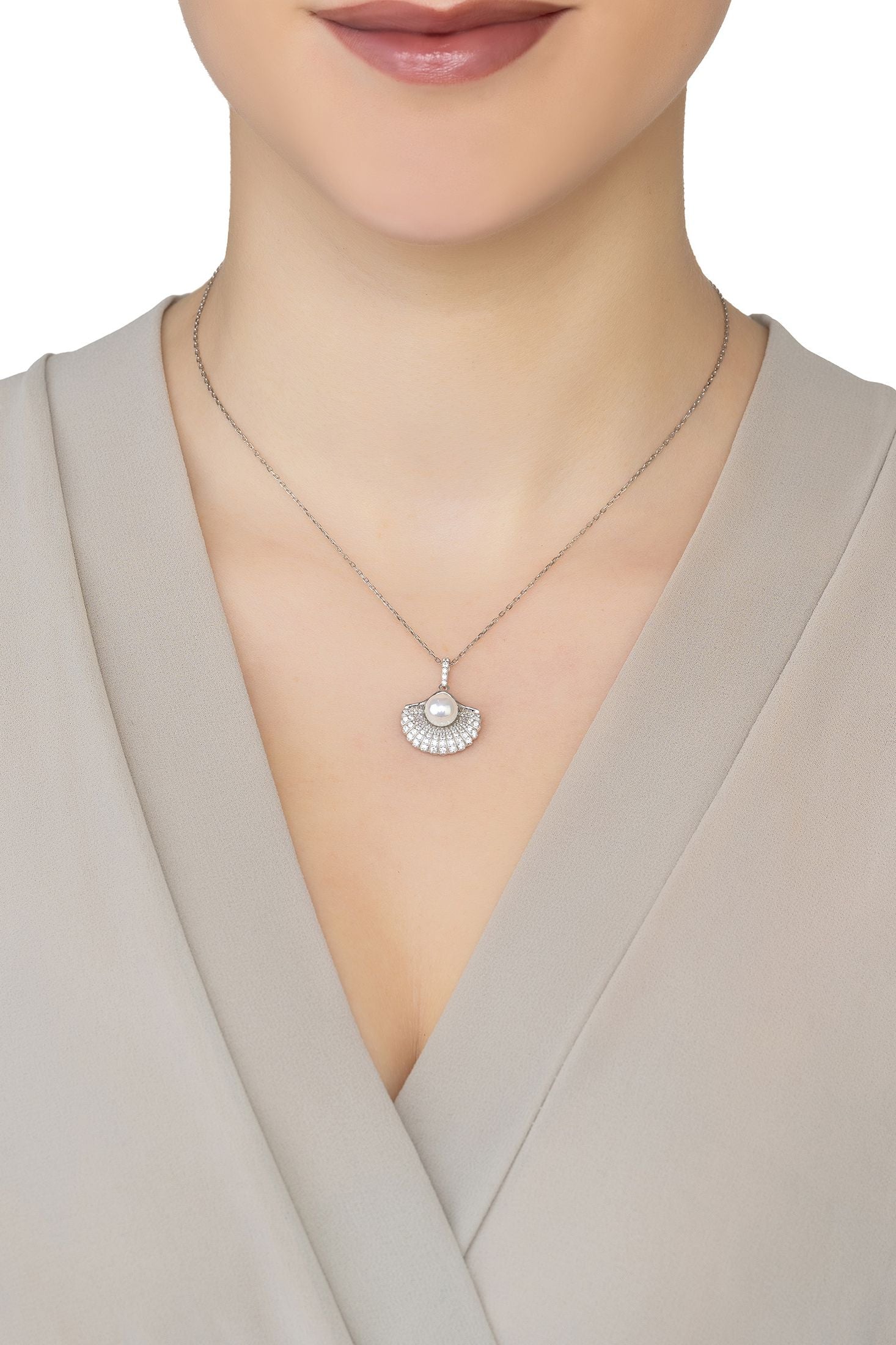 Angled view of Deco Fan And Pearl Shell Pendant Necklace Silver, showing shell design, pearl detailing, silver finish and the jewellery profile.