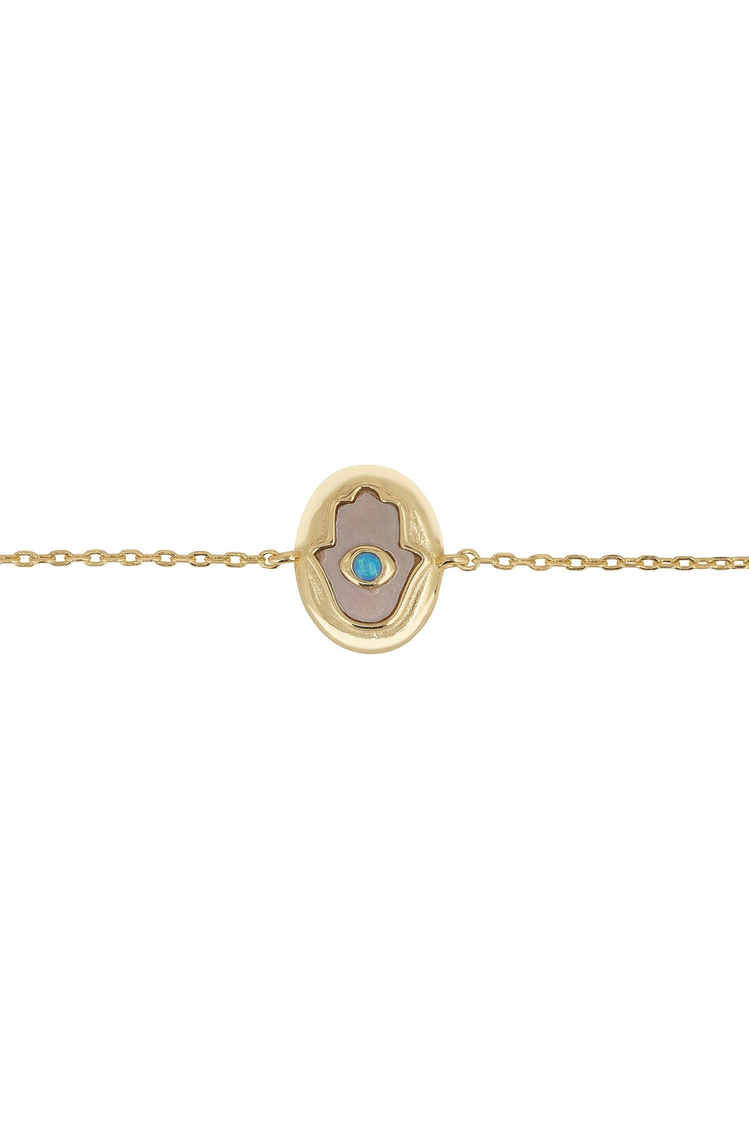 Gold bracelet with a circular charm featuring a blue gemstone on a white background