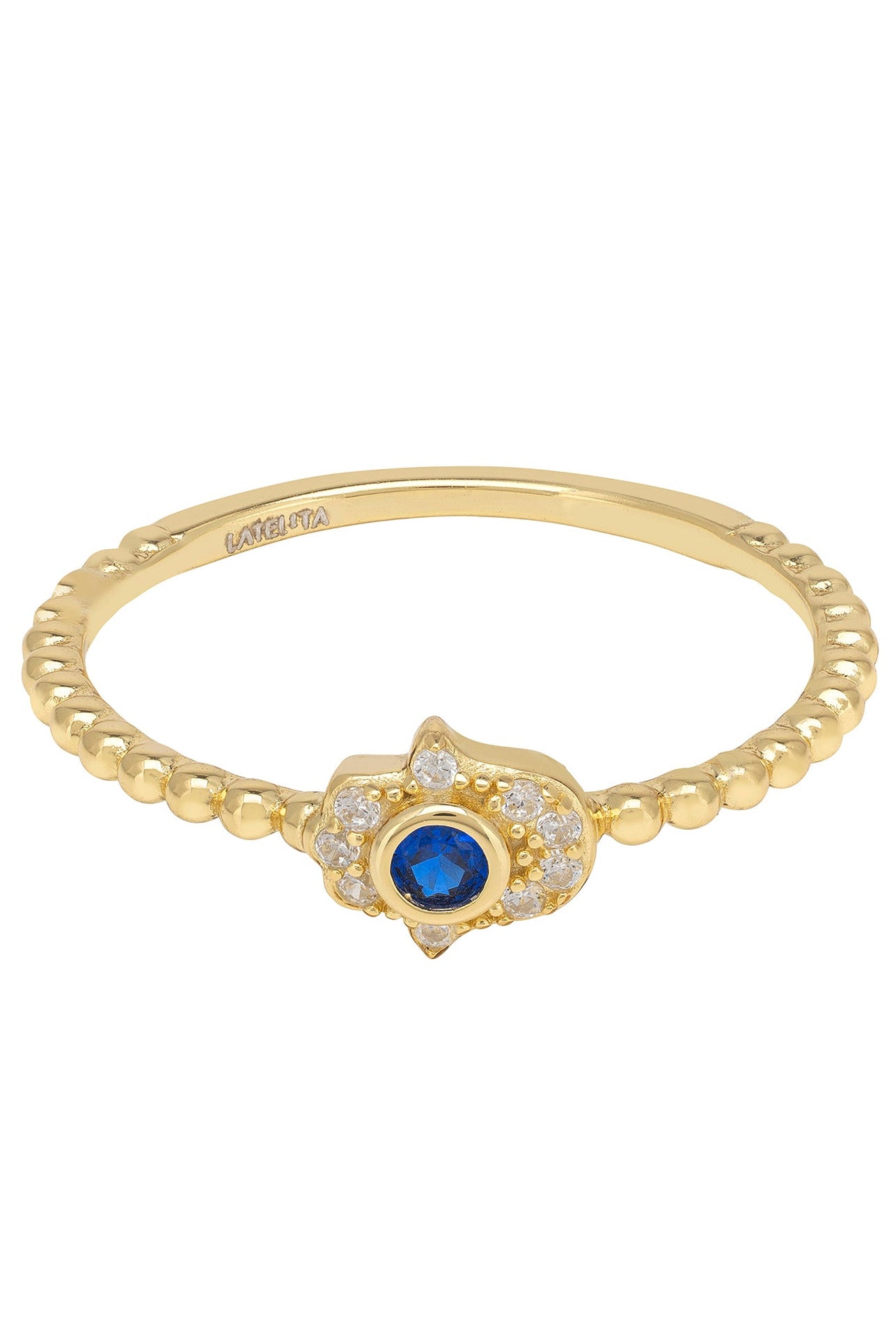 Gold ring with a blue gemstone and clear gemstone accents on a white background