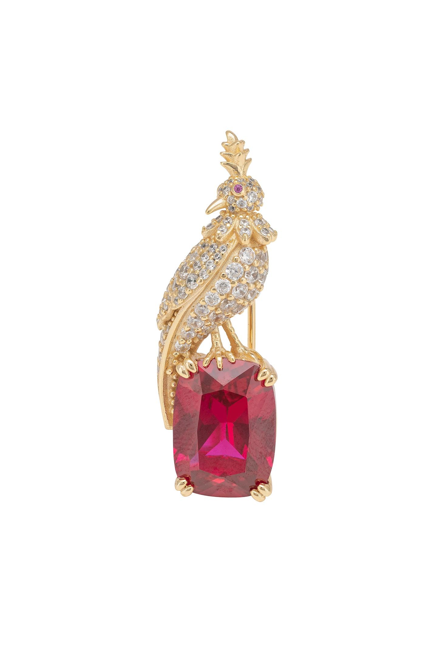 Gold bird-shaped brooch with a red gemstone on a white background