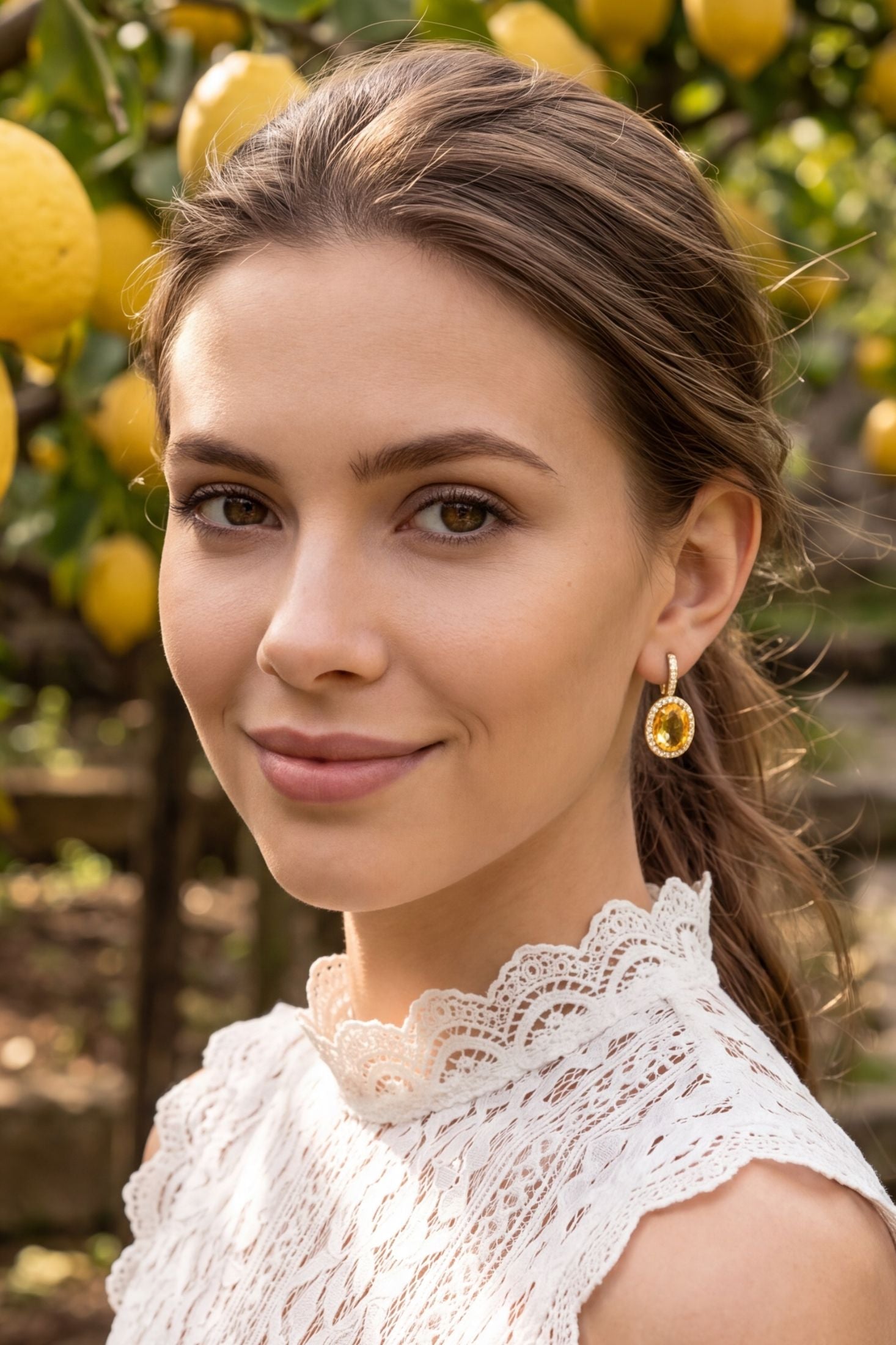 Angled view of Beatrice Oval Gemstone Drop Earrings Gold Citrine Hydro, showing citrine detailing, gold finish and the jewellery profile.