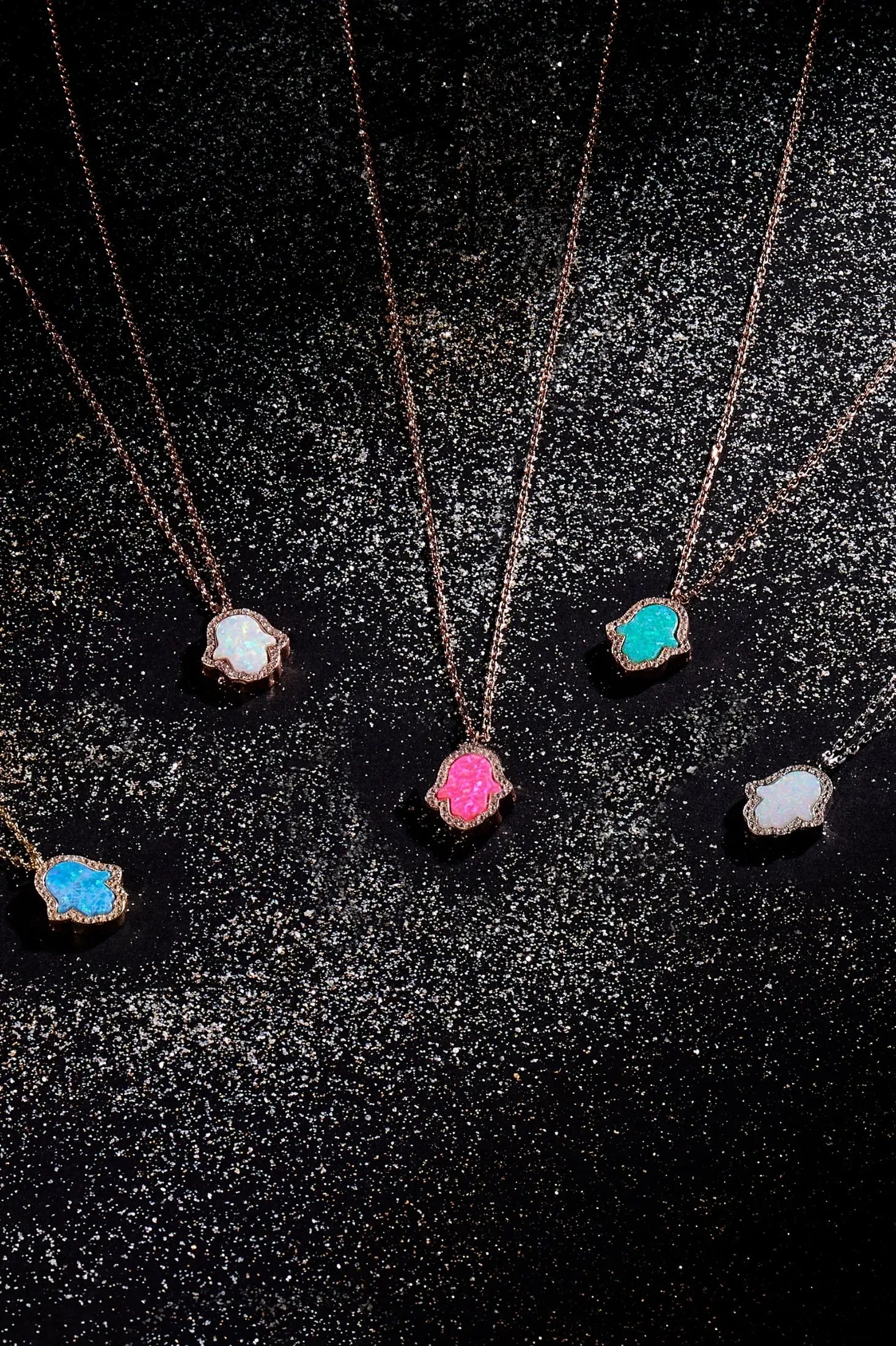 Hamsa hand necklaces with different opal and metal variants.