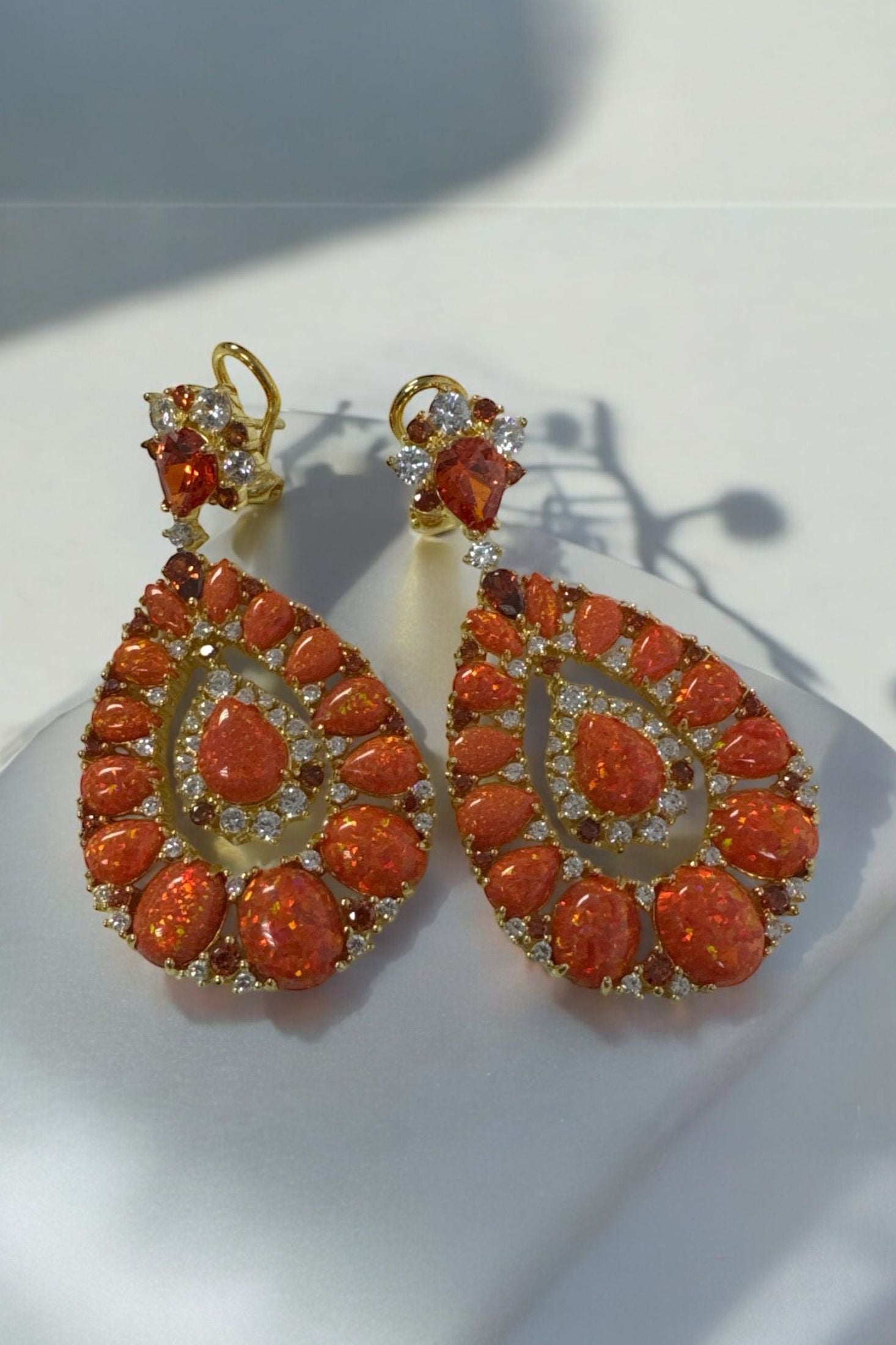 The earrings on a white surface.