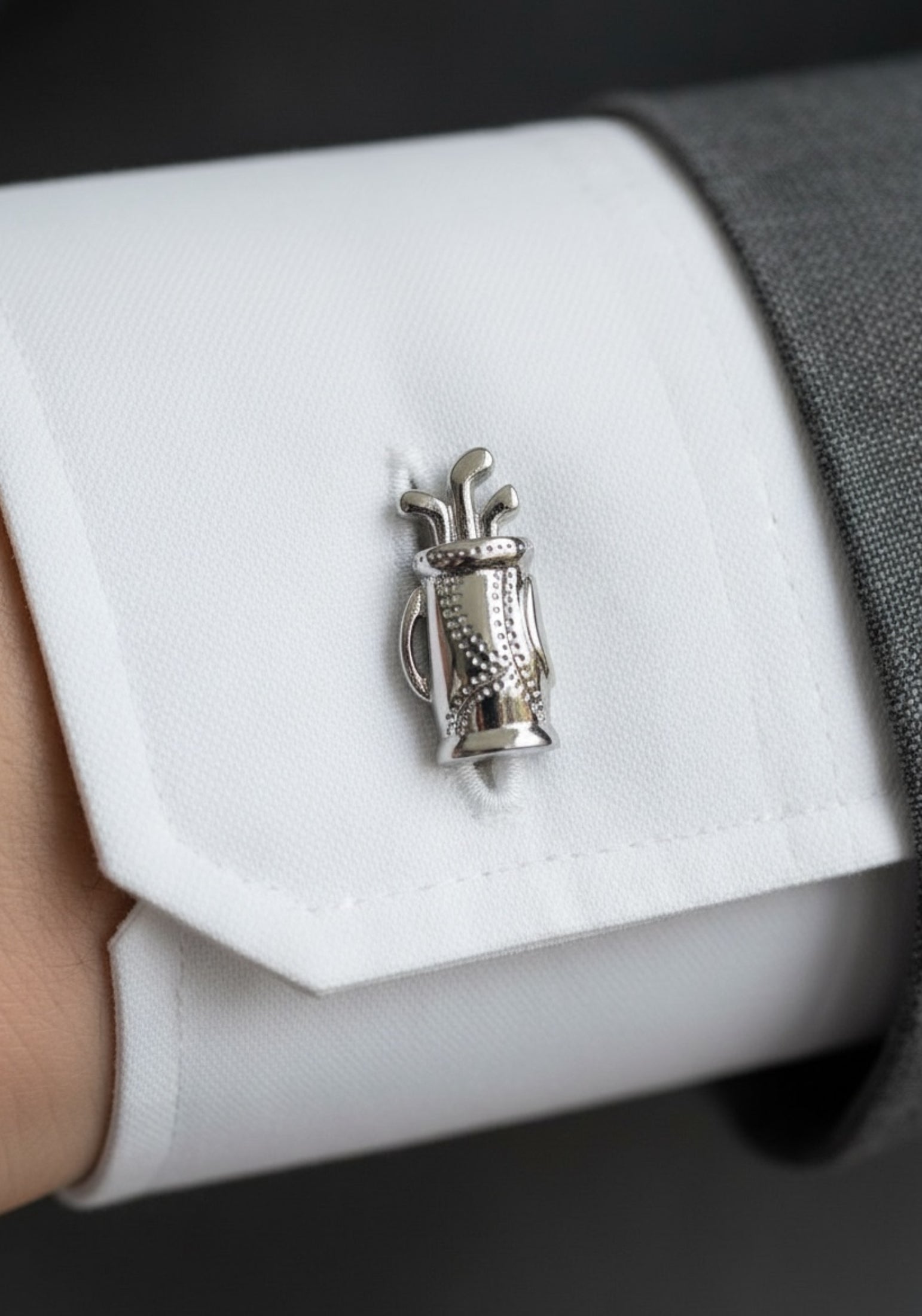 Close-up of the cufflink on a model wearing a suit.