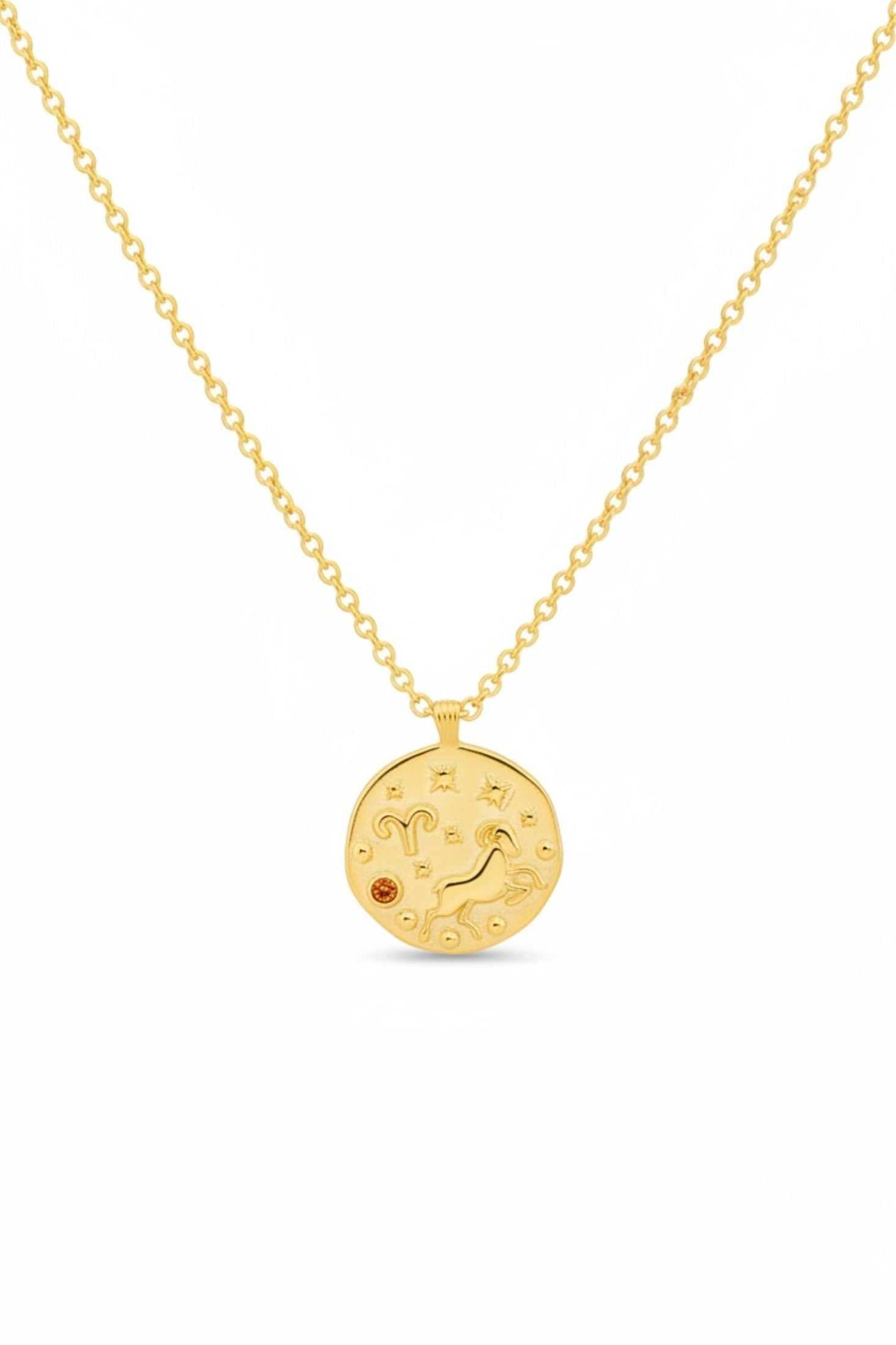 Gold necklace with a circular pendant on a white background