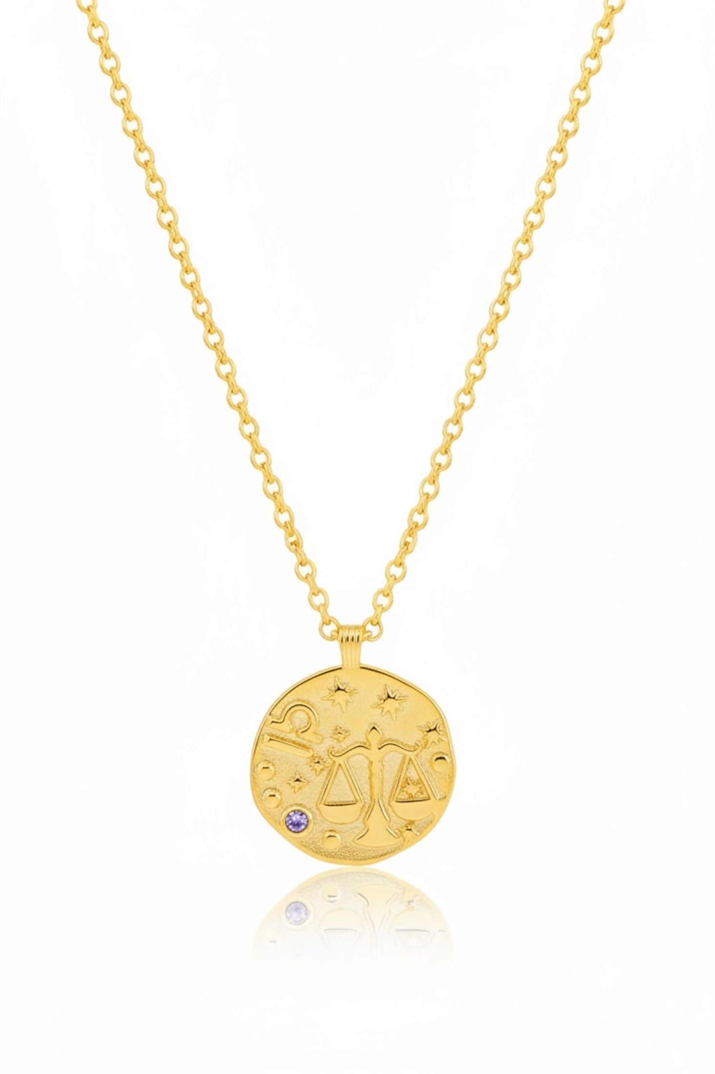 Gold necklace with a round pendant on a white background