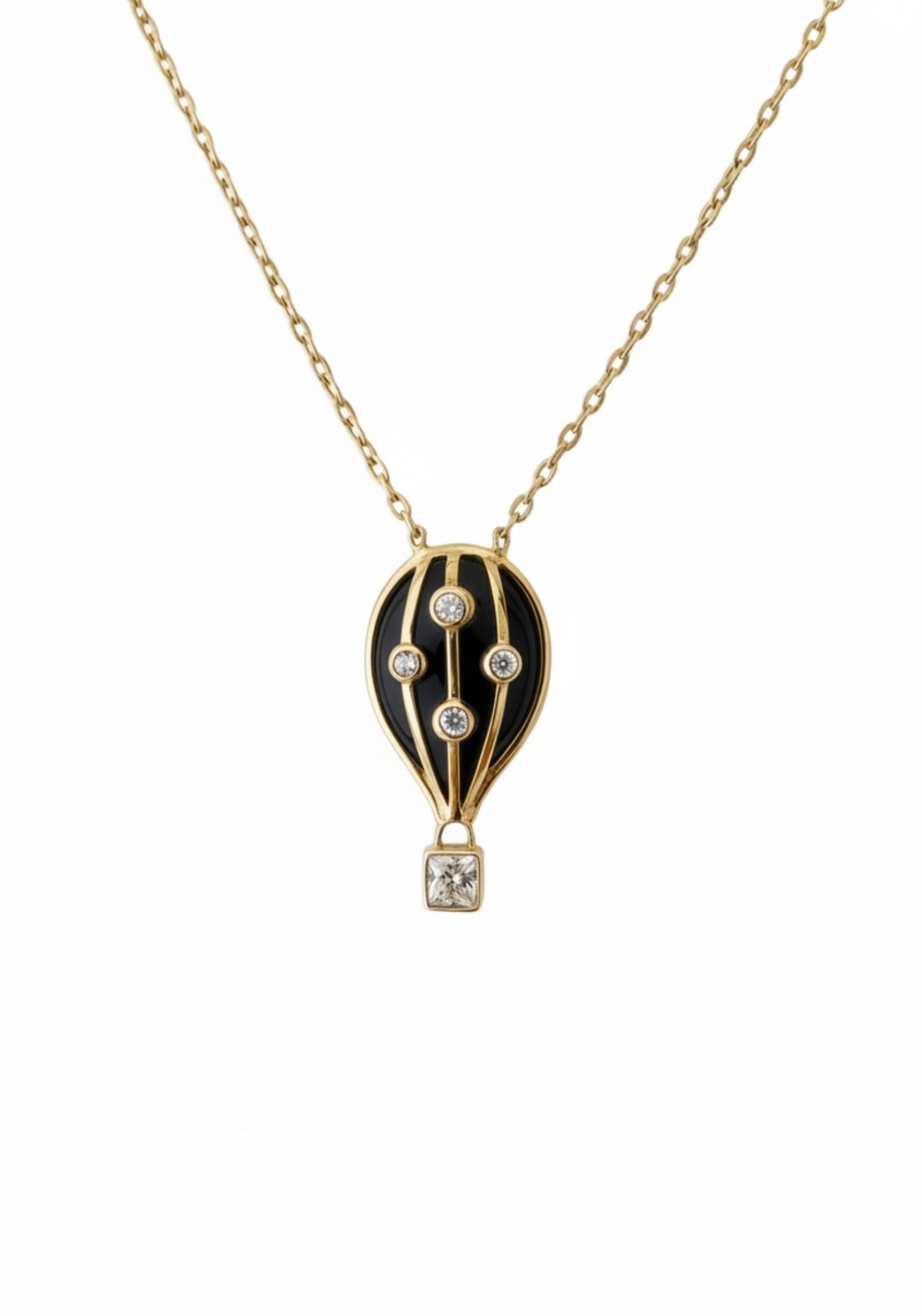 Gold necklace with a black hot air balloon pendant on a white background