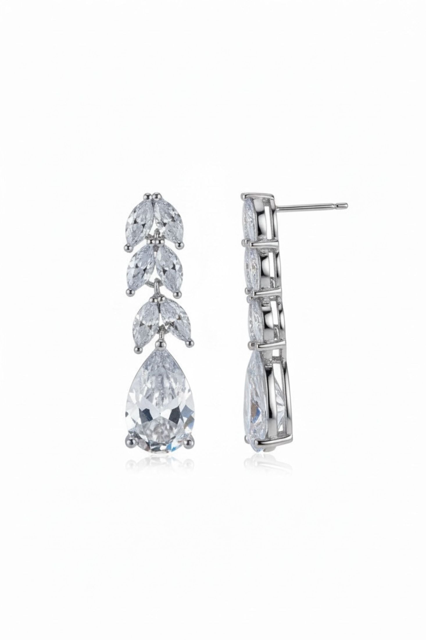 Pair of silver earrings with clear gemstones on a white background