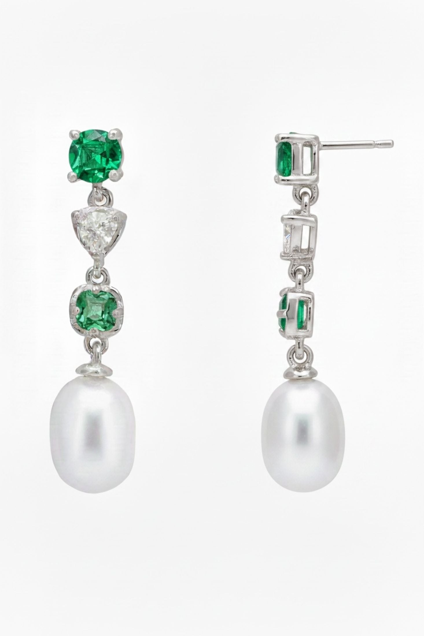 Angled view of Pearl Whisper Drop Earrings Emerald Silver, showing pearl and emerald detailing, silver finish and the jewellery profile.