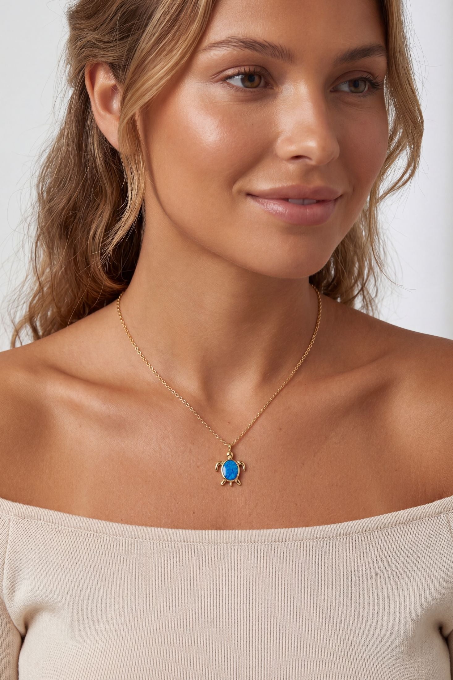 Angled view of Sea Turtle Blue Opal Pendant Necklace Gold, showing turtle design, gold finish and the jewellery profile.