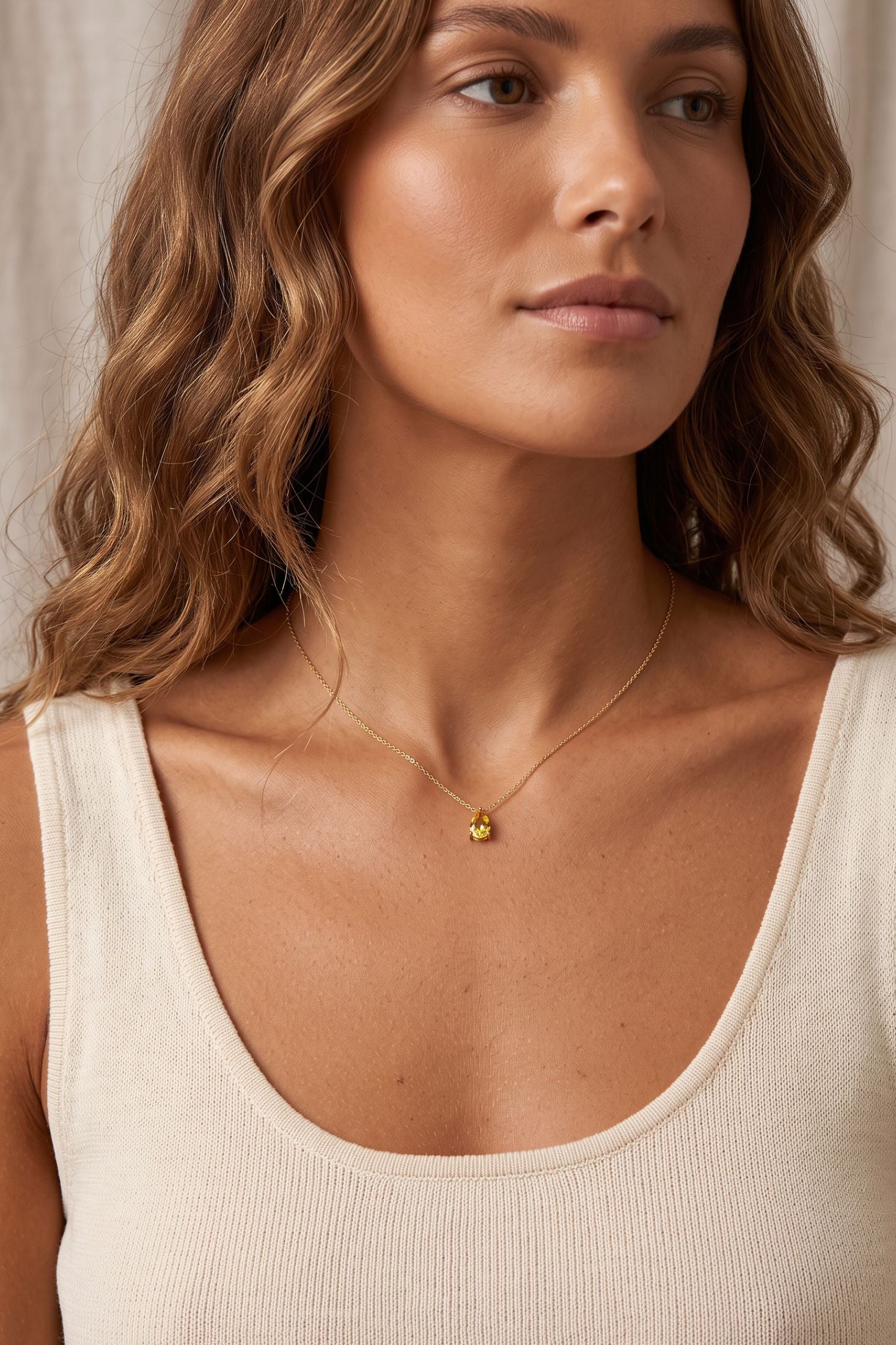 Angled view of Adele Teardrop Necklace Gold Citrine, showing citrine detailing, gold finish and the jewellery profile.