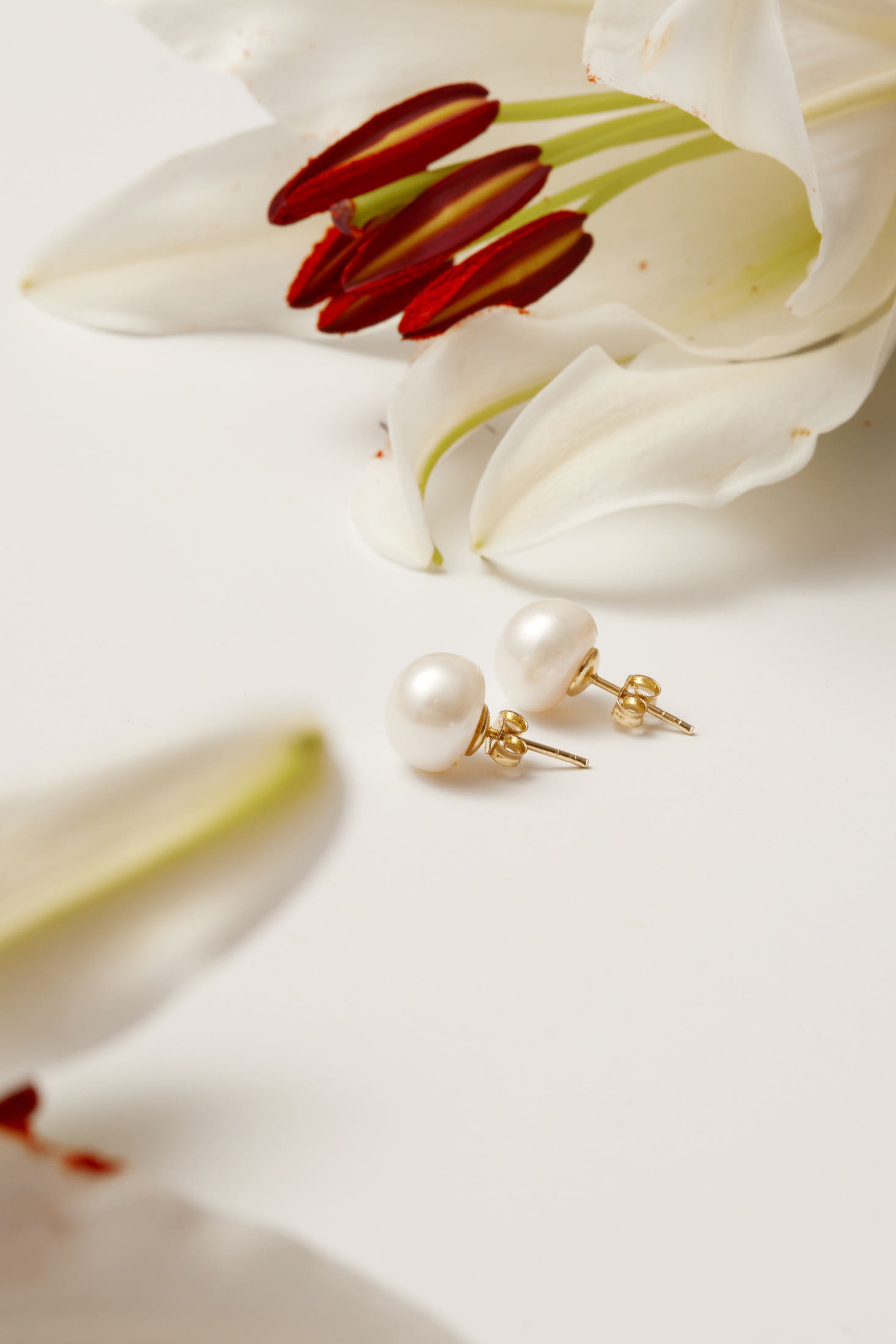Close-up of Solid 14K Gold 11mm Classic Natural Pearl Stud Earrings, highlighting pearl detailing, gold finish.