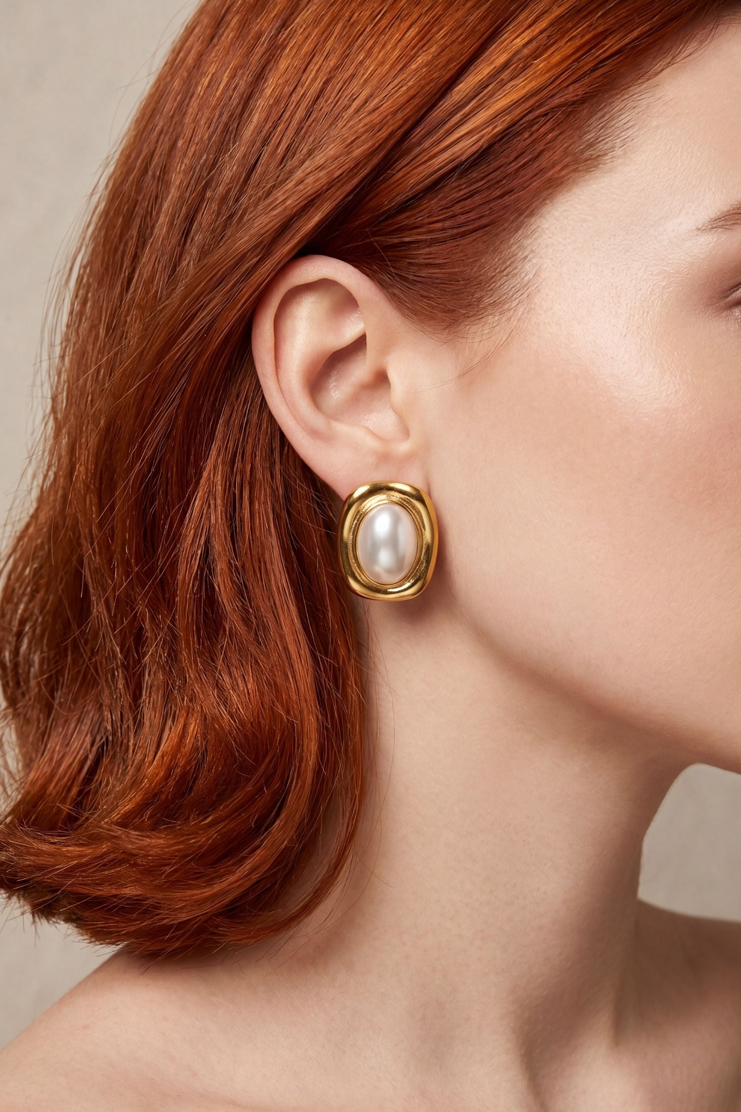 Close-up of Carrington Oval Pearl Knot Earrings Gold, highlighting pearl detailing, gold finish.