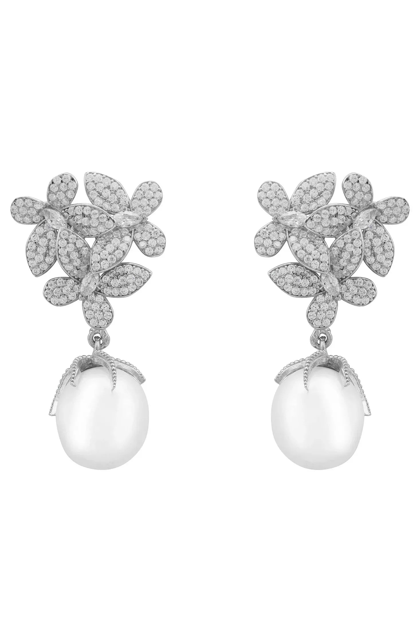 Pair of floral earrings with pearl drops on a white background