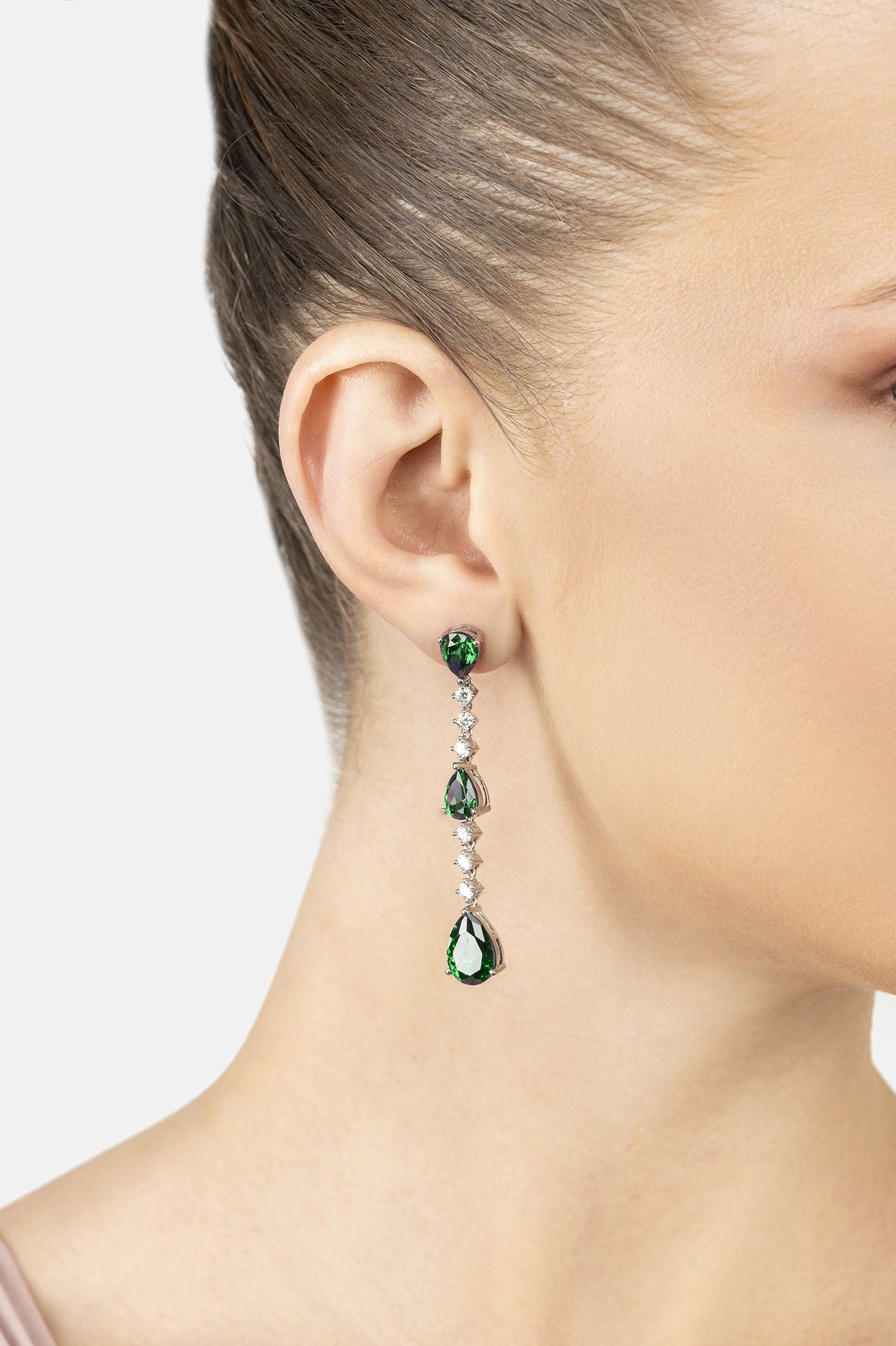 Close-up of Elizabeth Drop Earrings Emerald Silver, highlighting emerald detailing, silver finish.