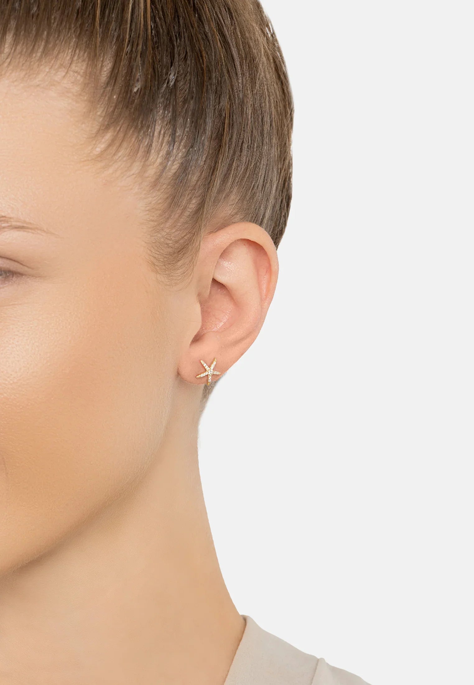 The earring worn by a model.