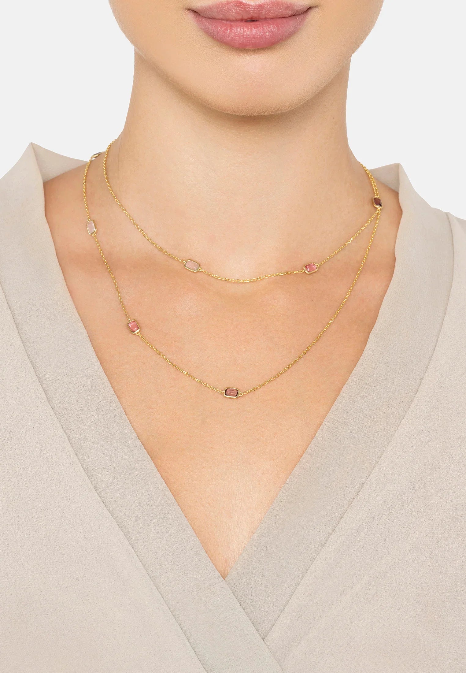 The necklace worn layered by a model.