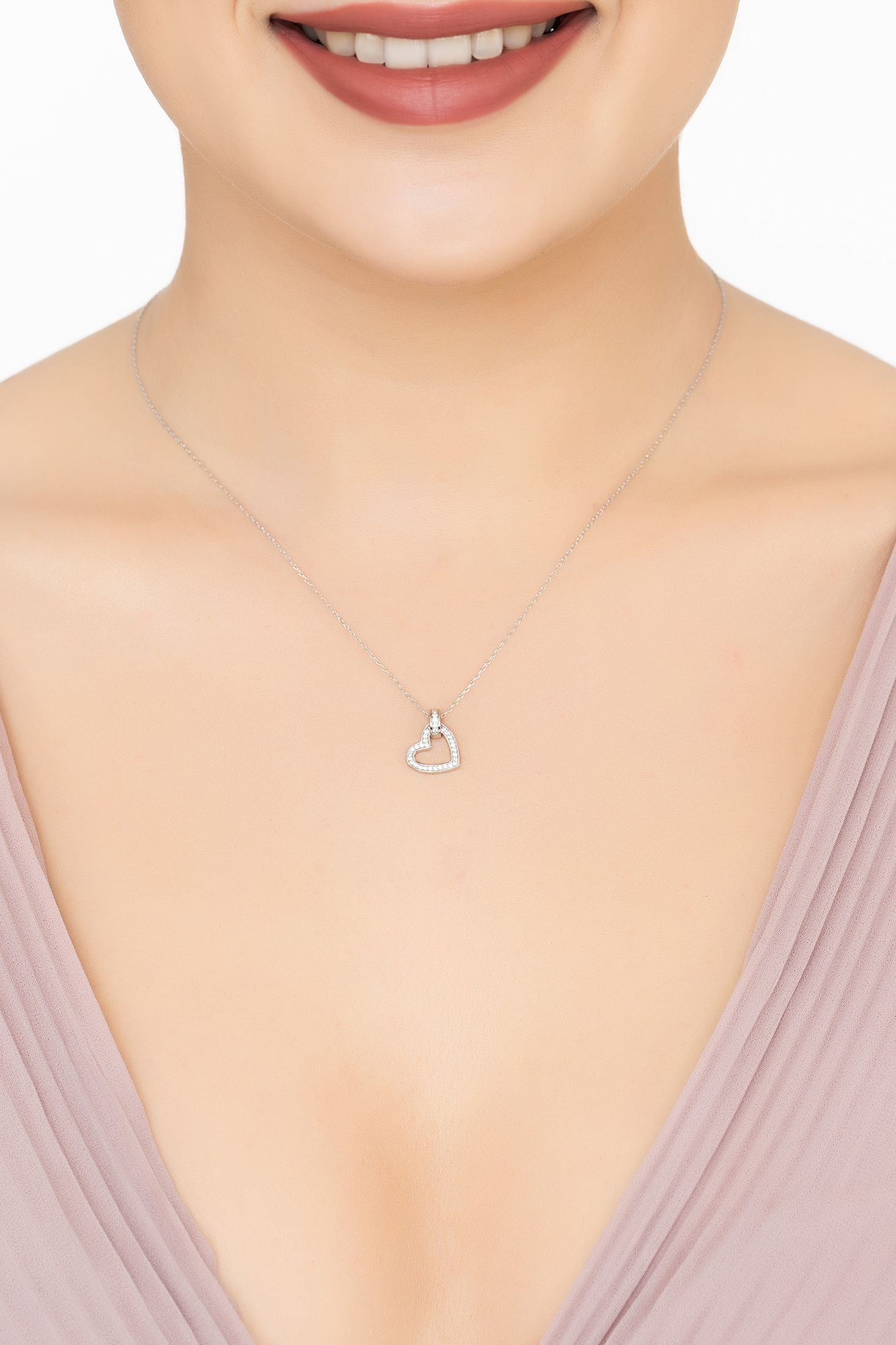 Angled view of Cherished Heart Pendant Necklace Silver, showing heart design, silver finish and the jewellery profile.