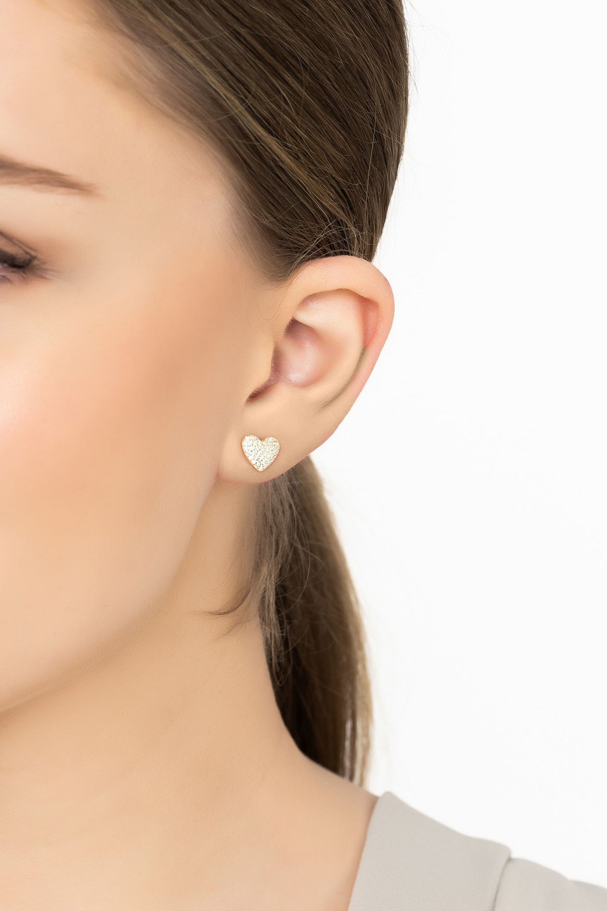 Angled view of Sweetheart Sparkle Stud Earrings Gold, showing heart design, gold finish and the jewellery profile.