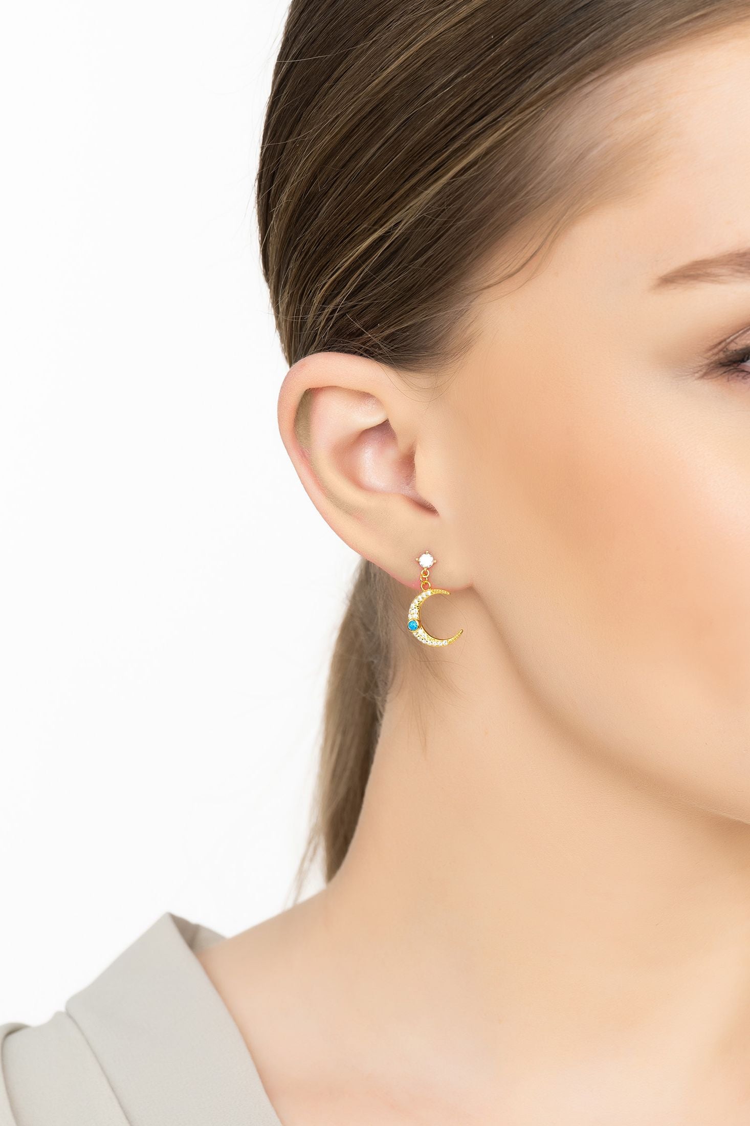 Angled view of Andromeda Star And Moon Earrings Gold, showing star design, gold finish and the jewellery profile.