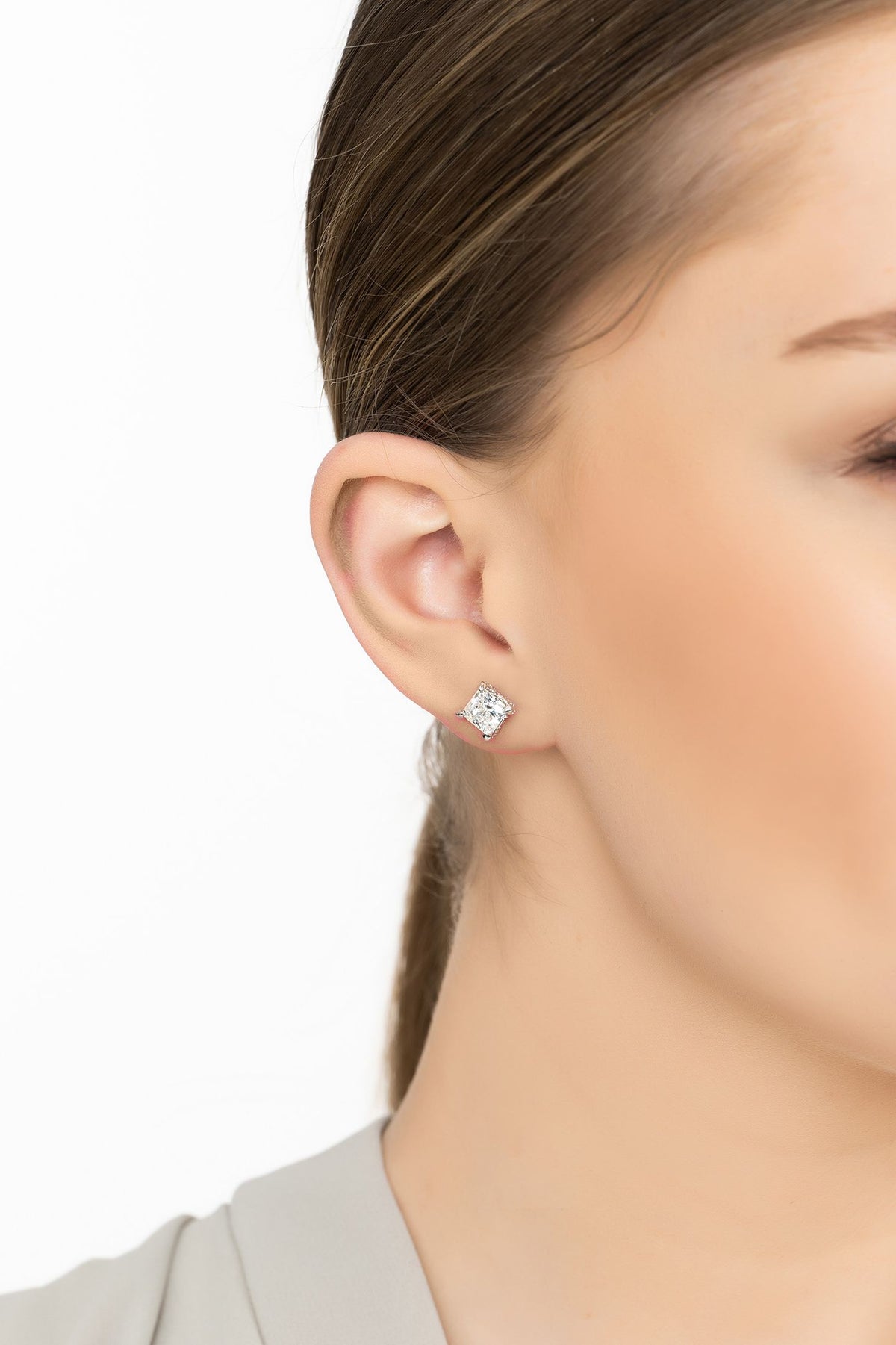 Angled view of Bel Air Square-Cut Solitaire Moissanite Stud Earrings Silver, showing silver finish and the jewellery profile.