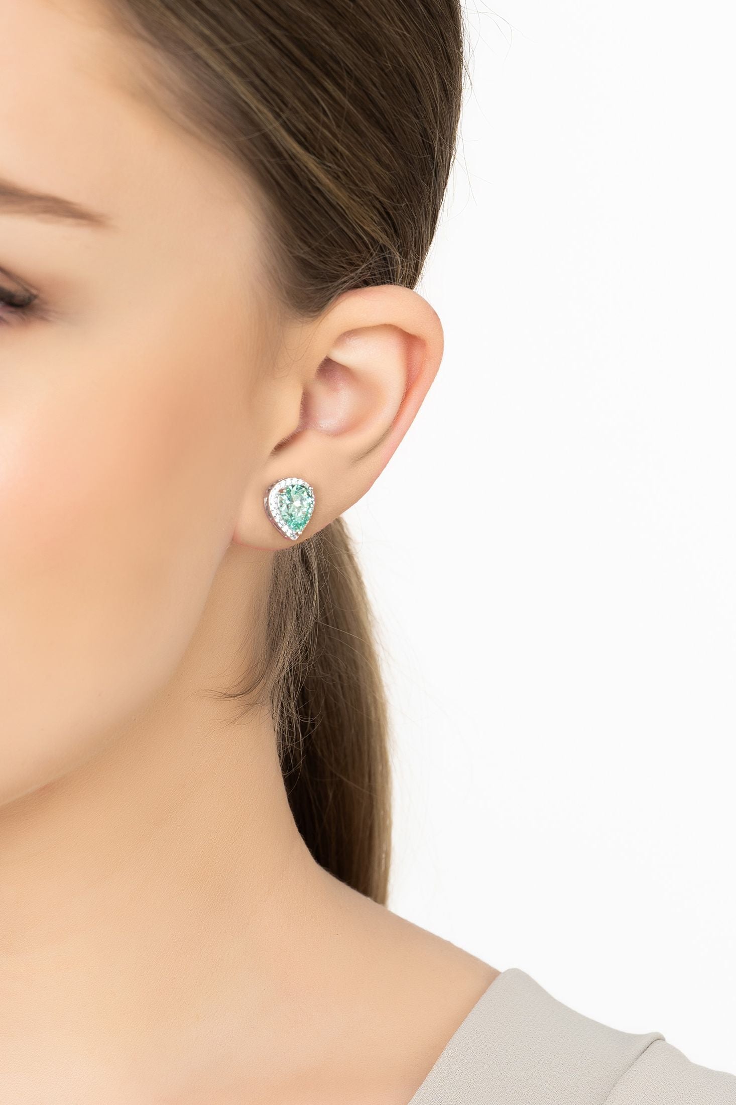 Angled view of Theodora Aquamarine Teardrop Gemstone Stud Earrings Silver, showing silver finish and the jewellery profile.