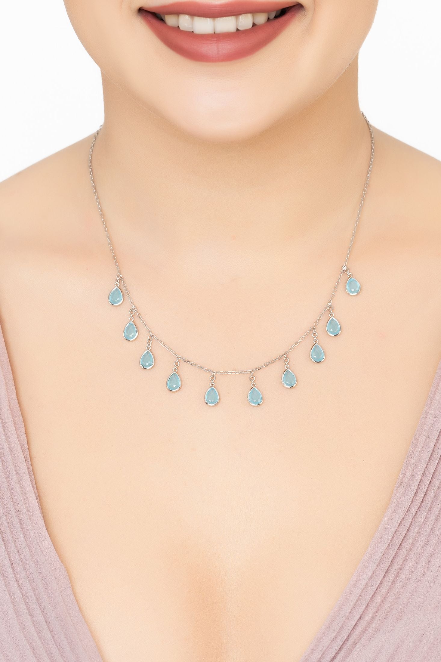 Angled view of Florence Teardrop Gemstone Necklace Silver Blue Chalcedony, showing chalcedony detailing, silver finish and the jewellery profile.