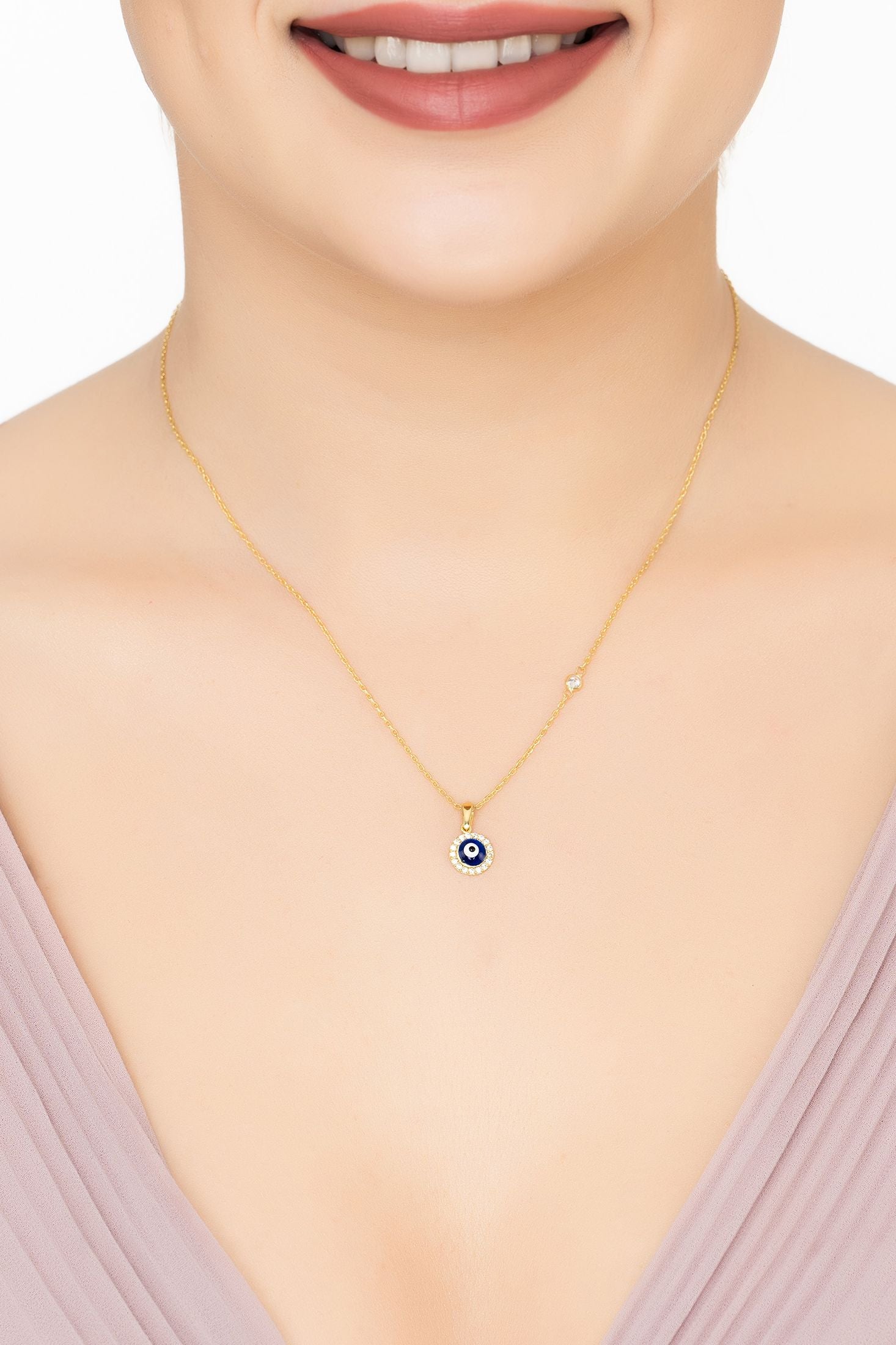 Angled view of Evil Eye Dark Blue Enamel Pendant Necklace Gold, showing evil eye design, gold finish and the jewellery profile.