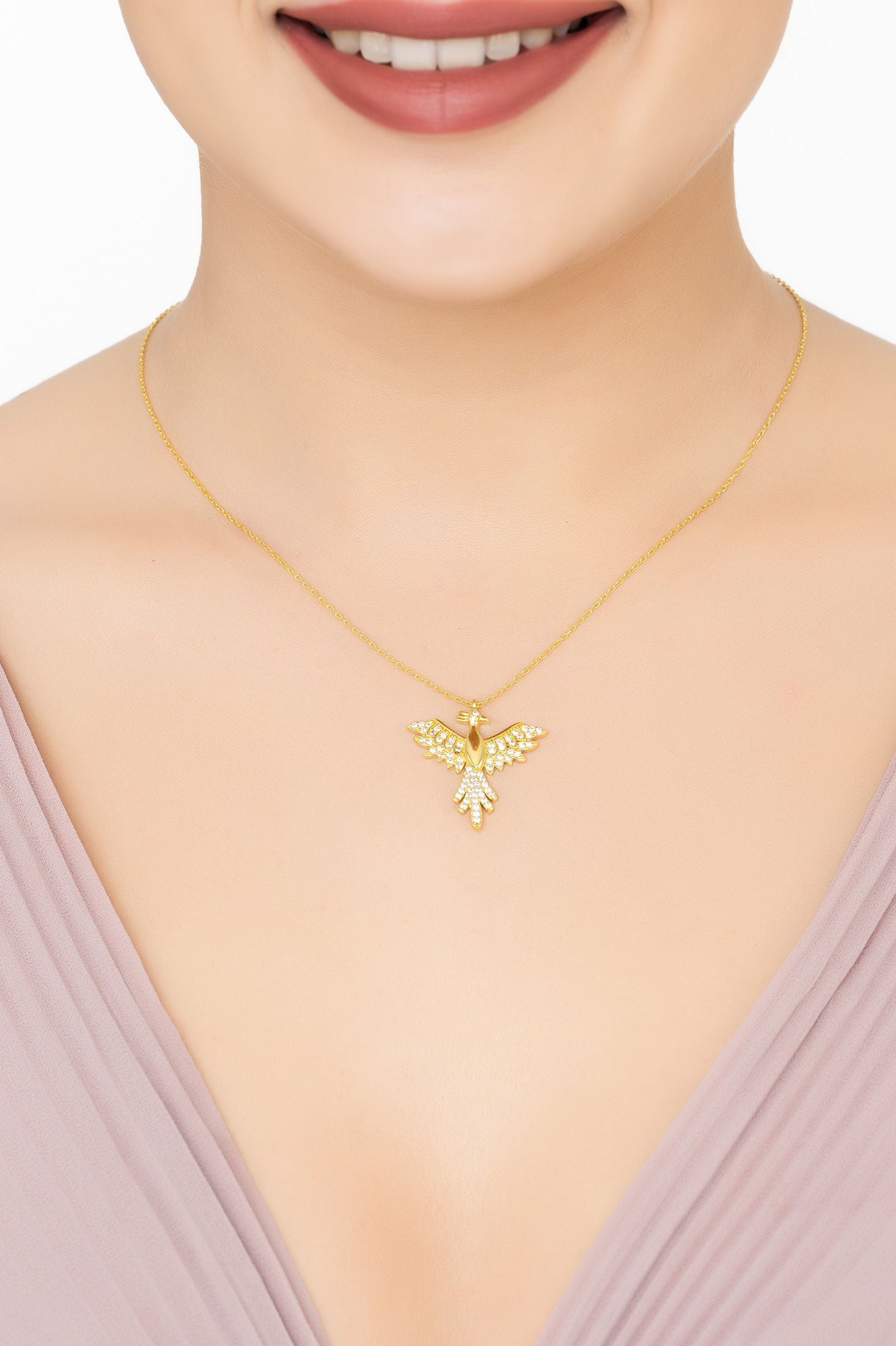 Angled view of Rising Phoenix Bird Pendant Necklace Gold, showing bird design, gold finish and the jewellery profile.