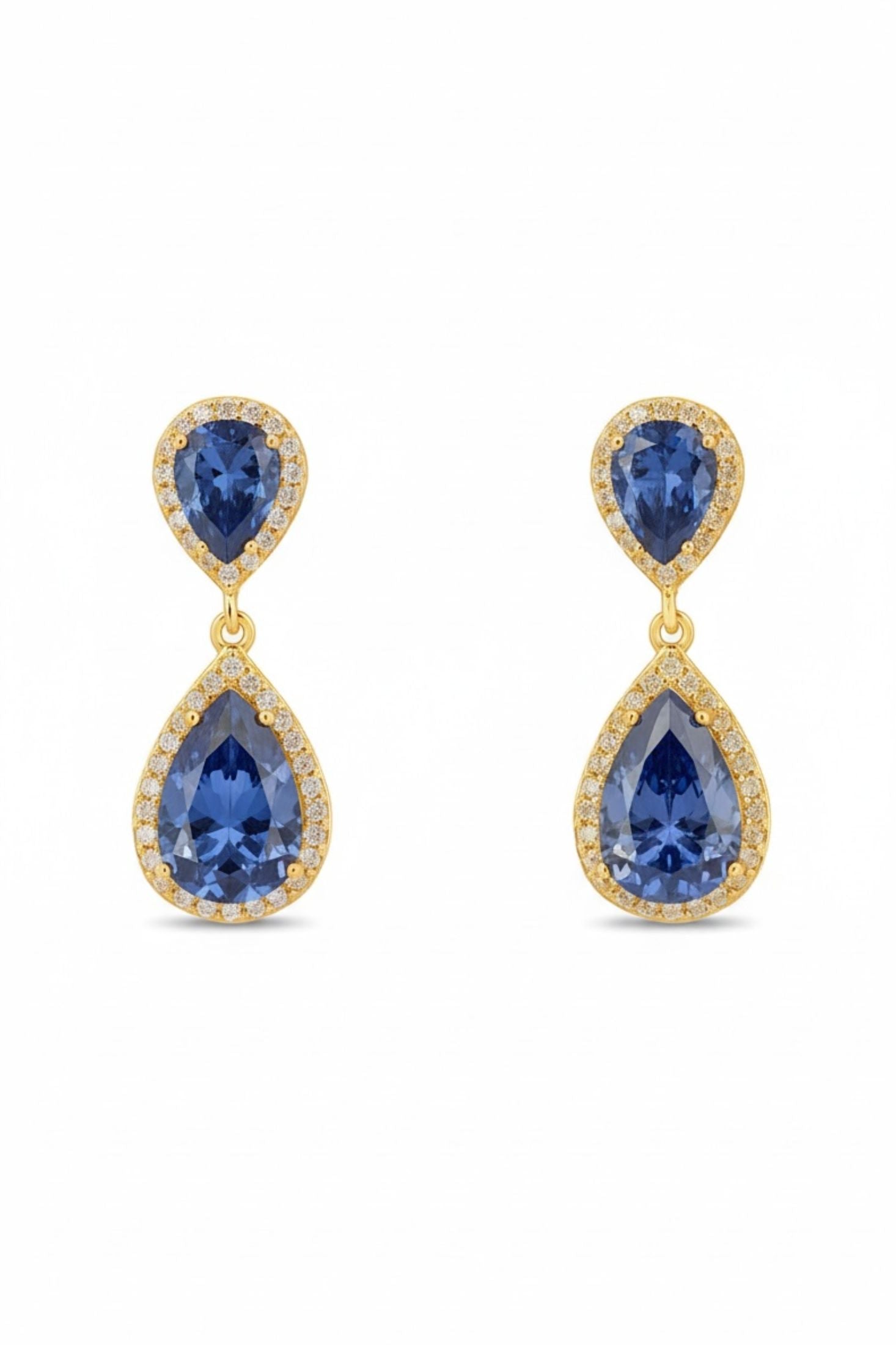 Pair of gold earrings with blue gemstones on a white background