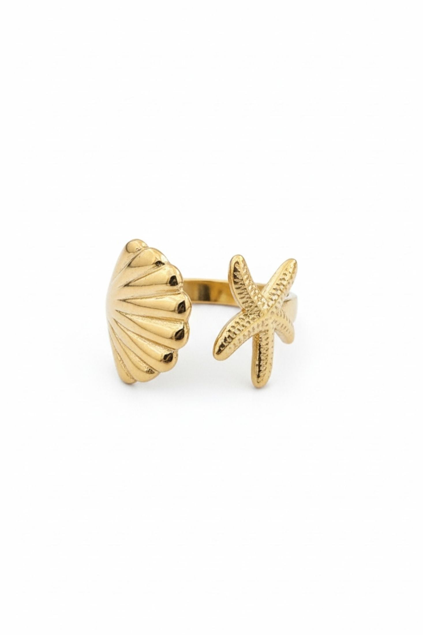 Gold shell and starfish-shaped ring on a white background