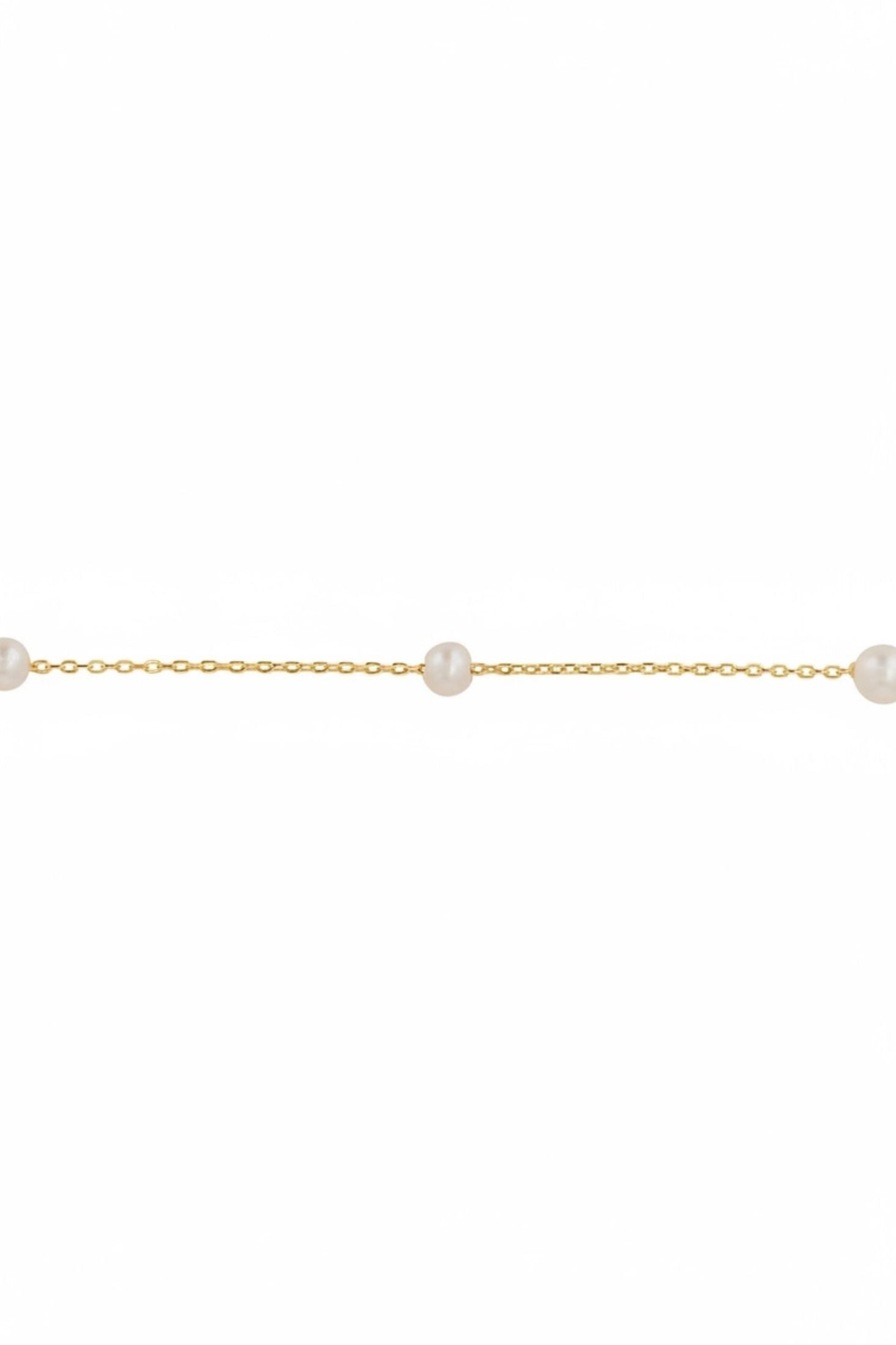 Gold chain bracelet with pearls on a white background