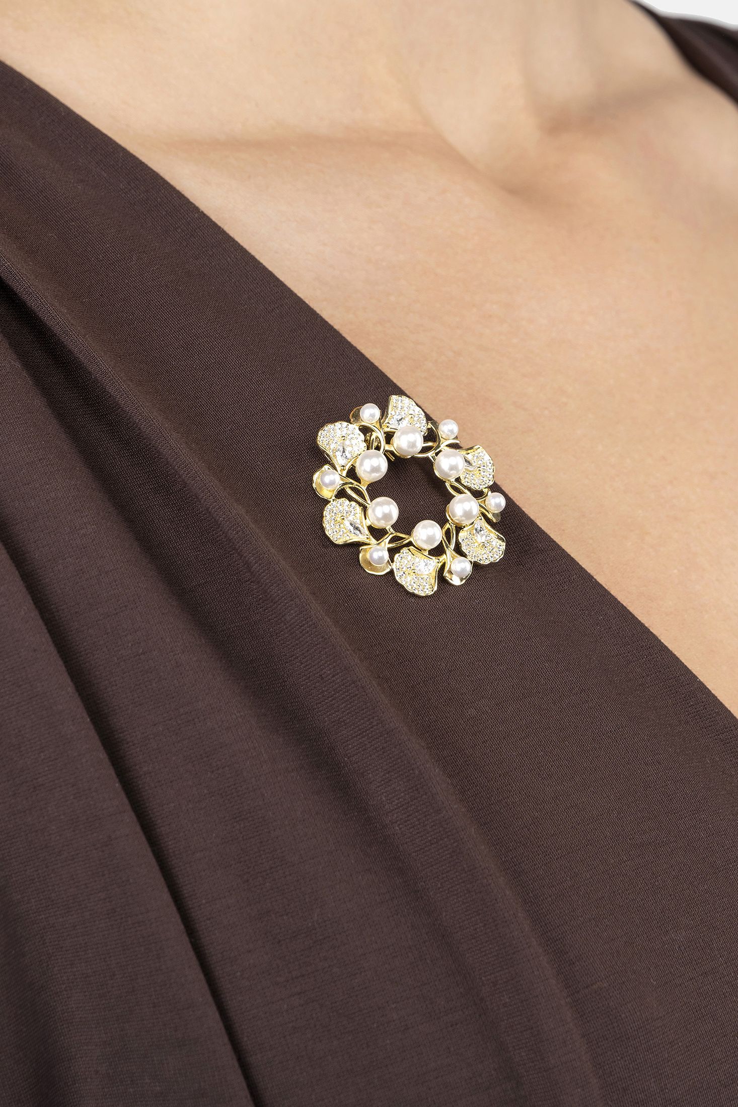Angled view of Ginkgo Leaf And Pearl Wreath Brooch Gold, showing leaf design, pearl detailing, gold finish and the jewellery profile.