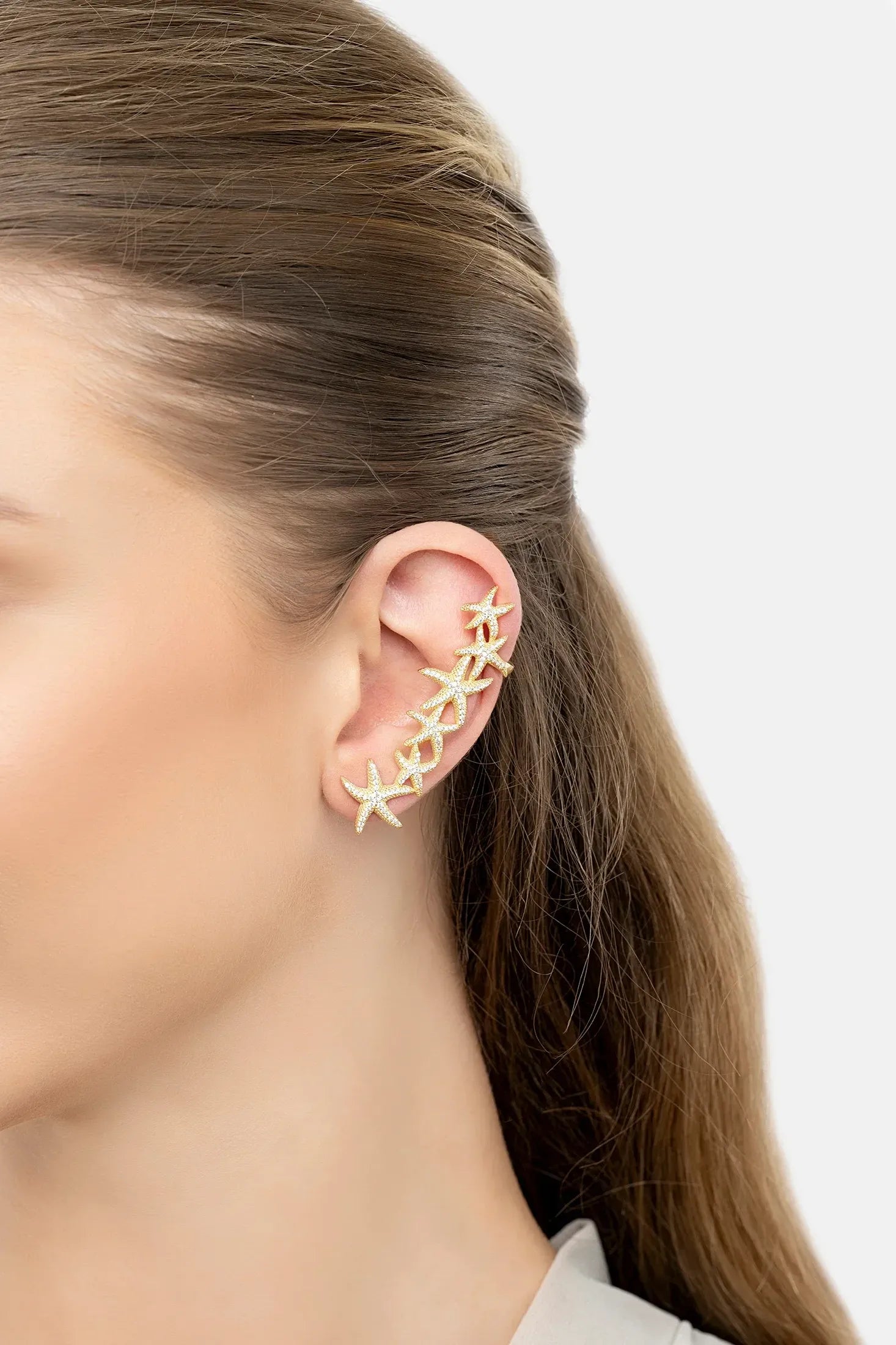 The earring worn by a model.