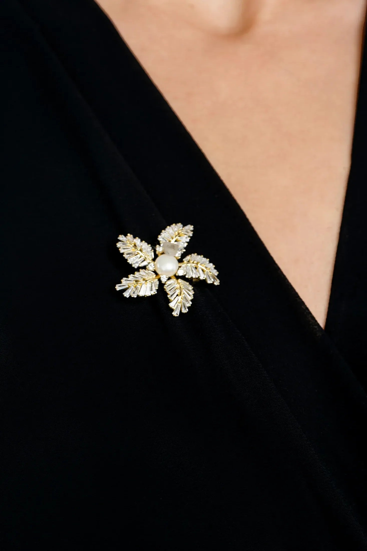 The brooch worn by a model.