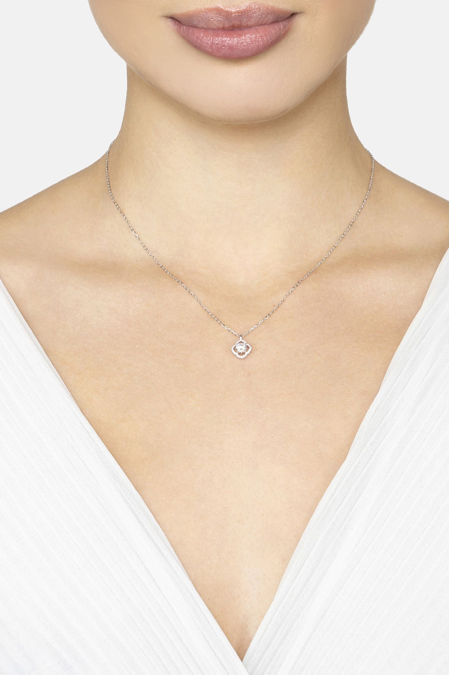 Necklace with a pendant worn by a person against a white background