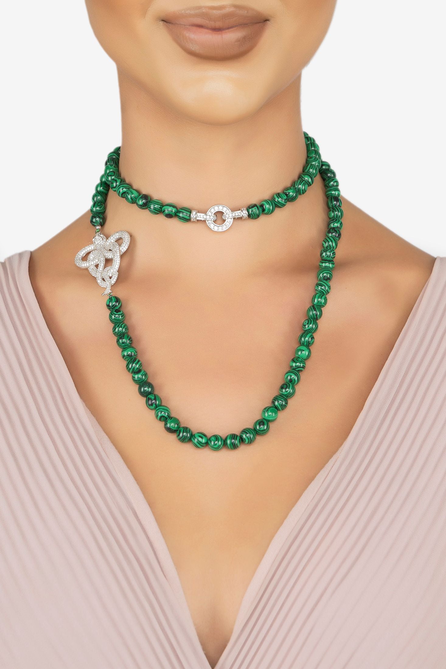 The necklace worn layered by a model.