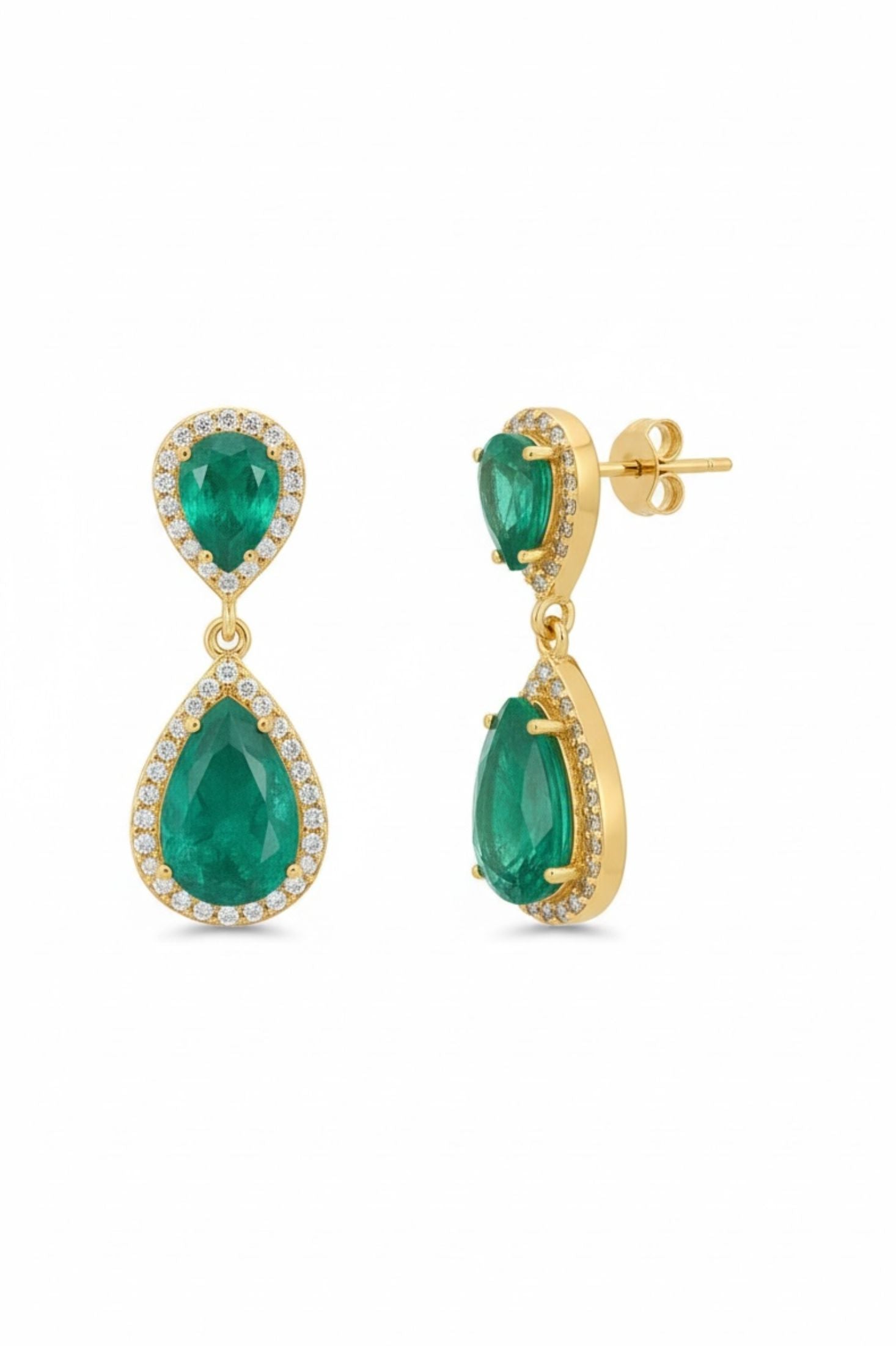 Gold earrings with green gemstones on a white background