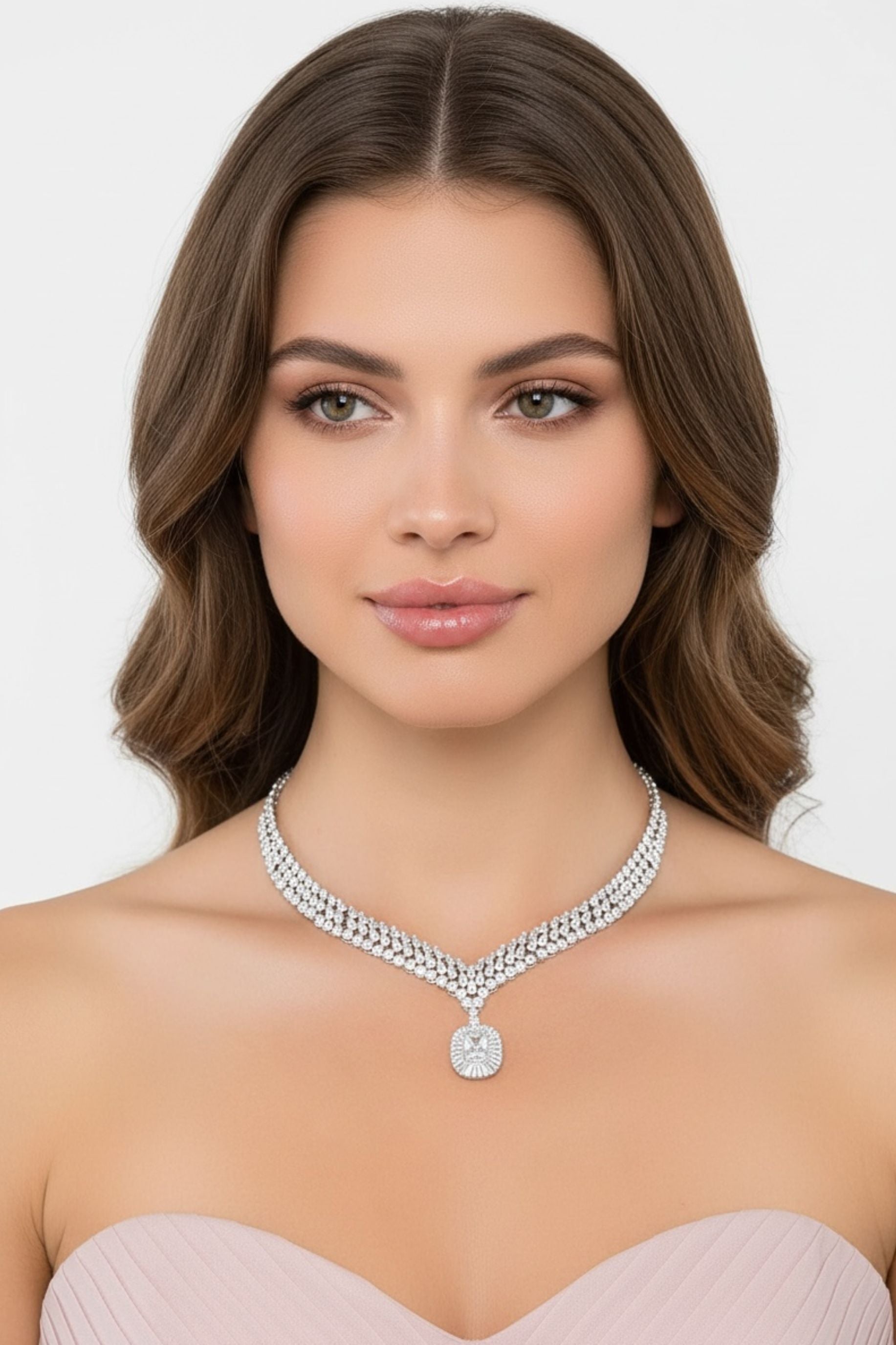 Woman wearing a sparkling statement necklace against a plain background