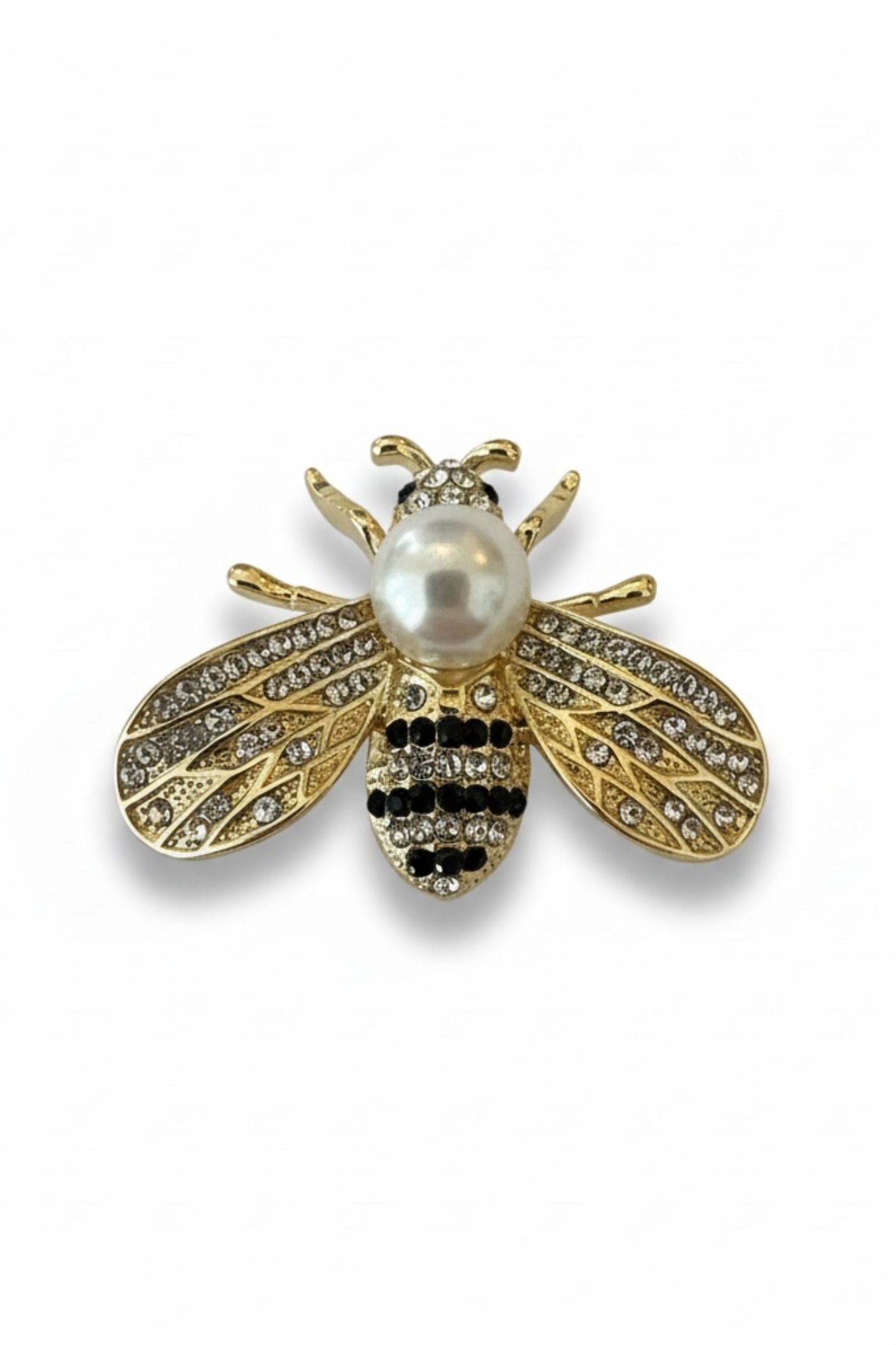 Jeweled bee brooch with pearl body on a white background