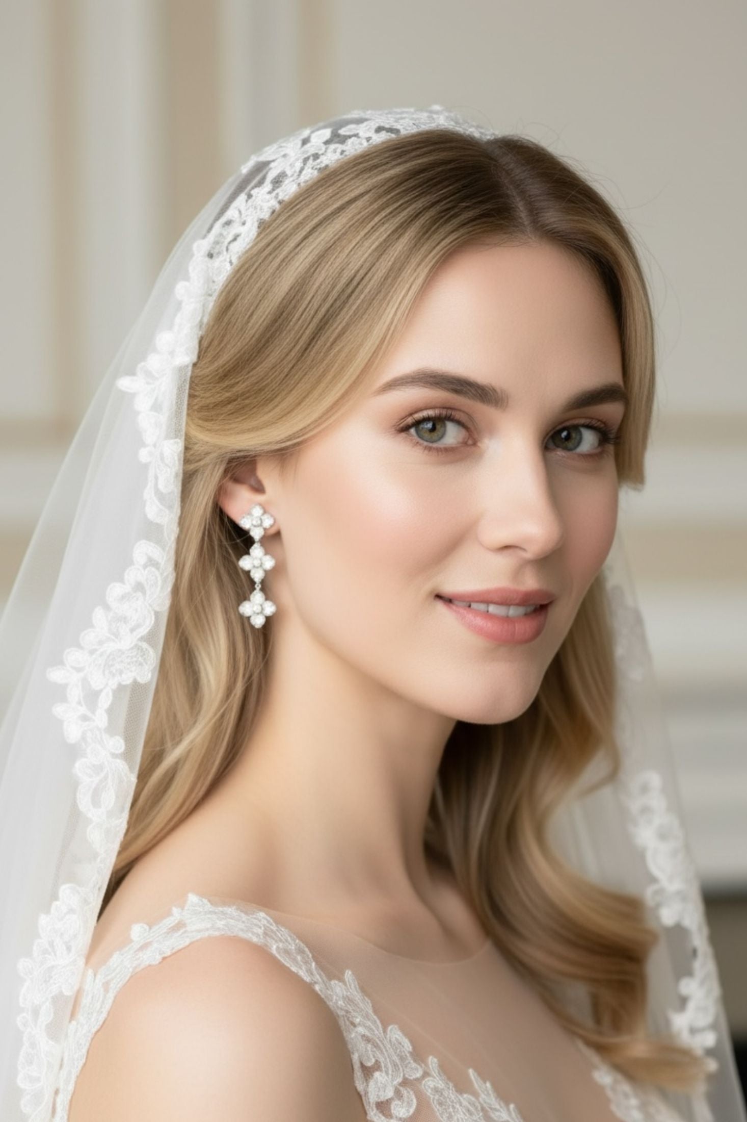 Woman wearing a white lace veil and white clover earrings
