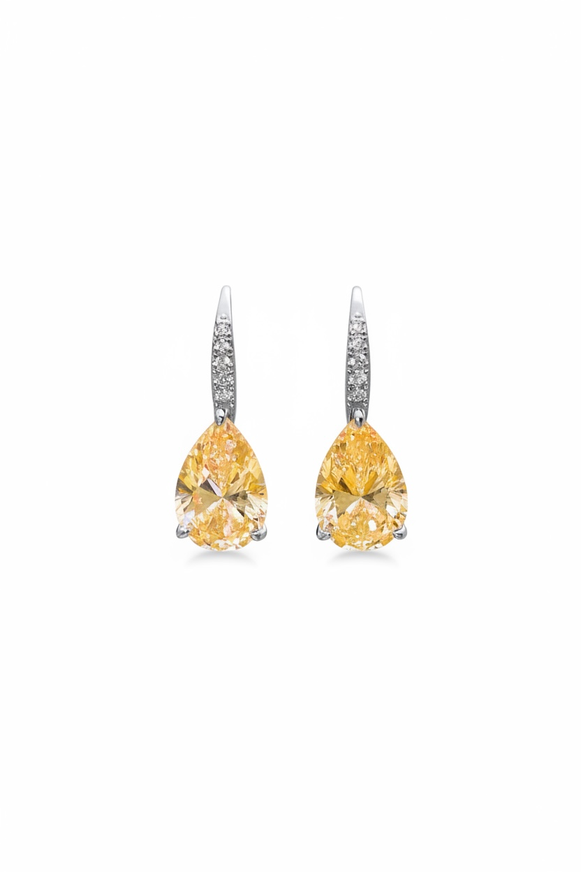 Pair of yellow pear-shaped gemstone earrings on a white background