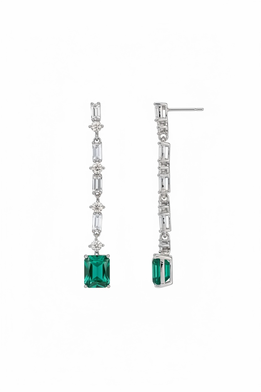 Pair of earrings with green gemstones on a white background