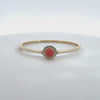 Rotating display of the red stone gold bangle.