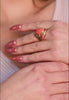 Close-up of the ring worn by a model.