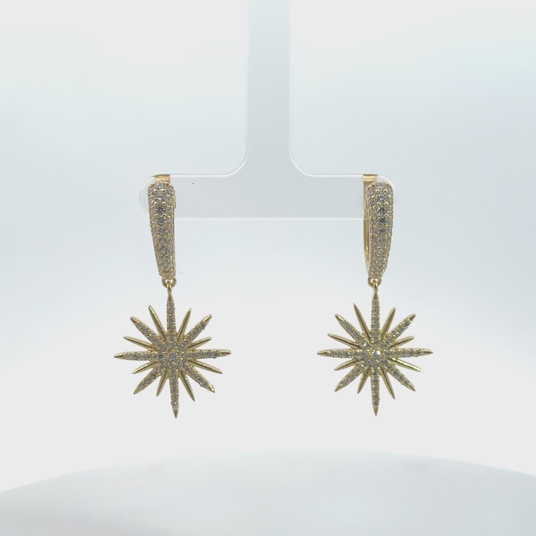 Video of Star Burst Drop Earrings Gold, showing the drop, movement and scale from multiple angles.