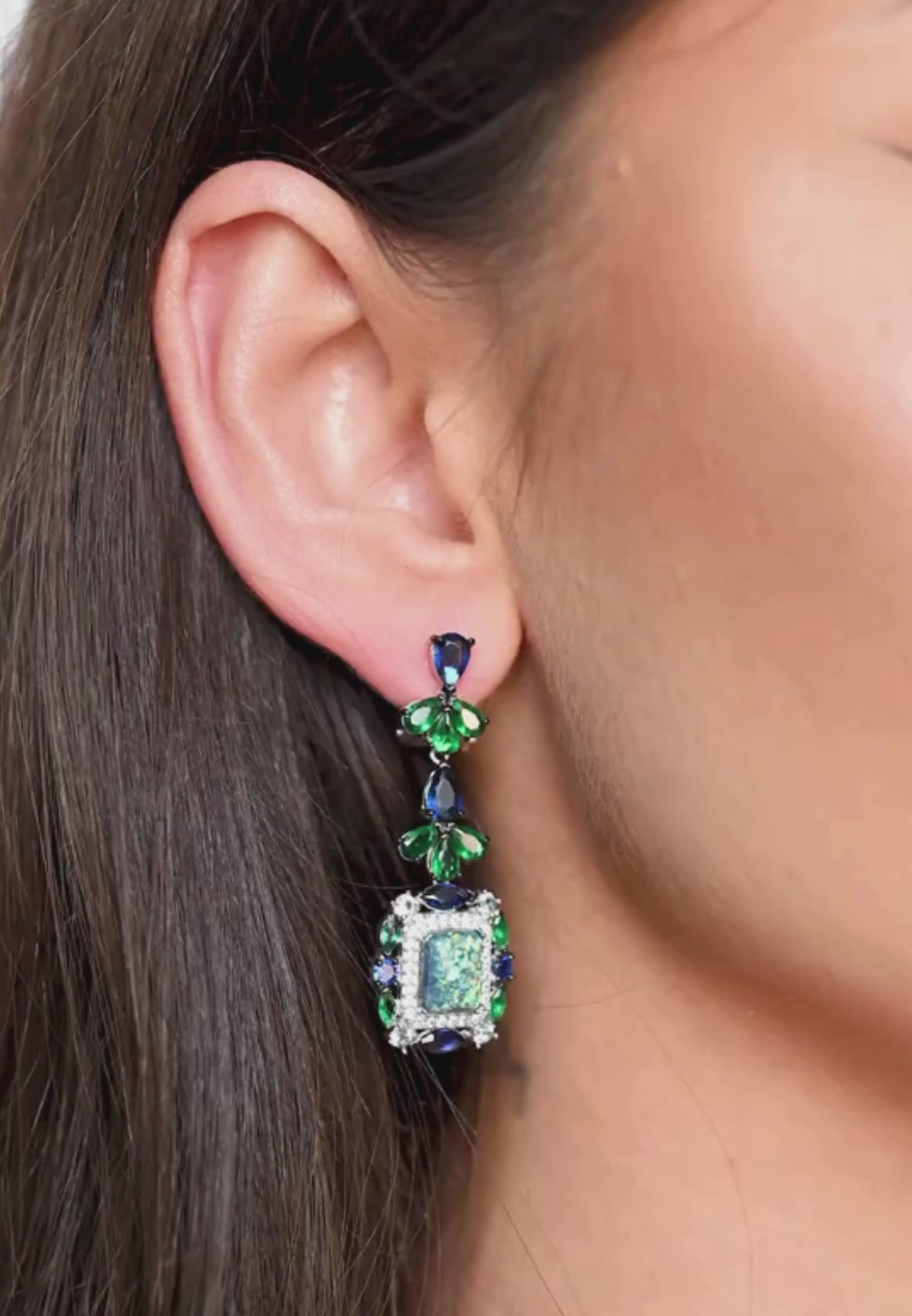 Close-up of the earring worn by a model.