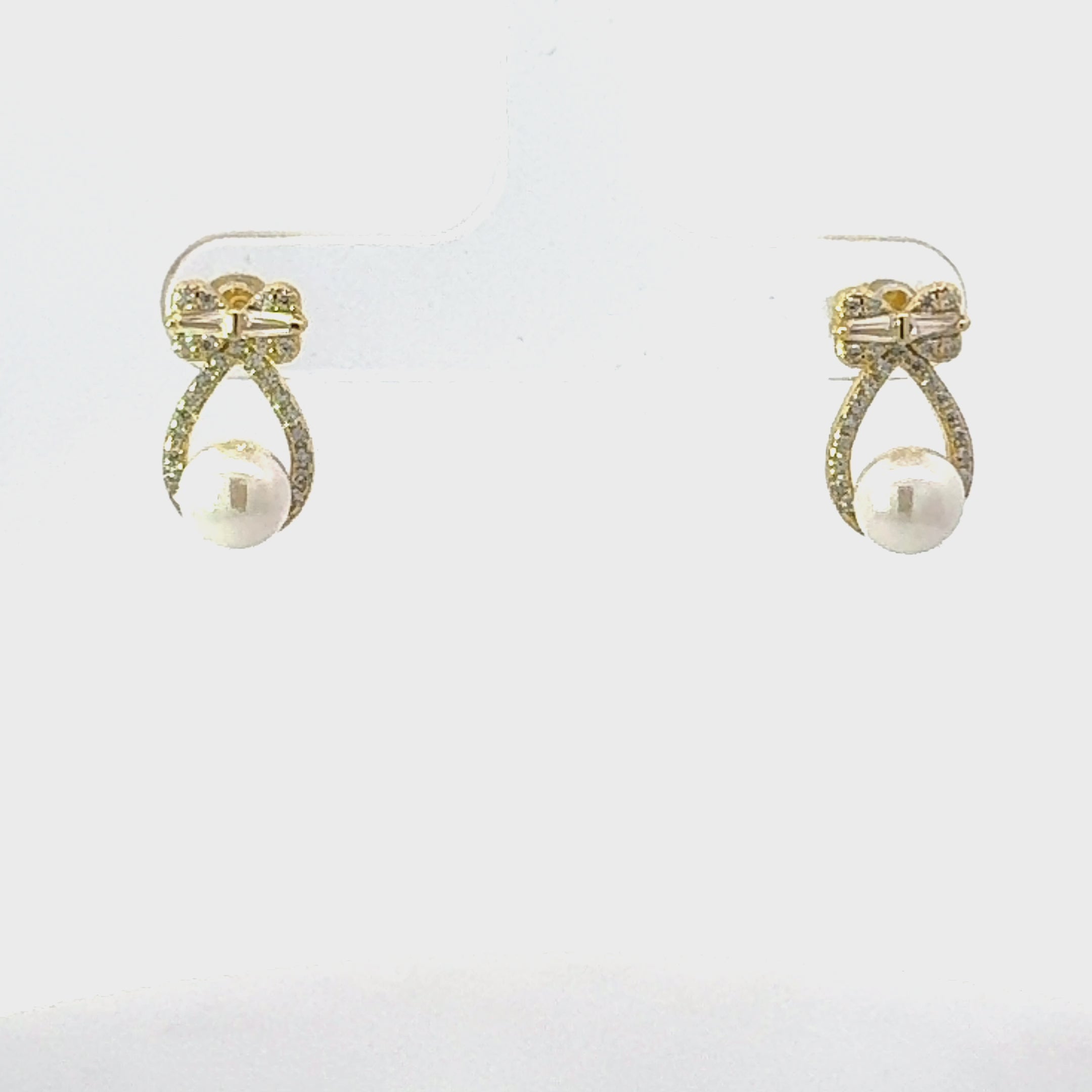 Video of Bows And Pearls Earrings Gold, showing the drop, movement and scale from multiple angles.